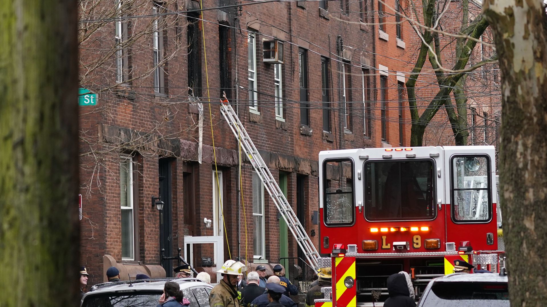 Philadelphia firefighters work at the scene of a deadly row house fire, Wednesday, Jan. 5, 2022, in Philadelphia.