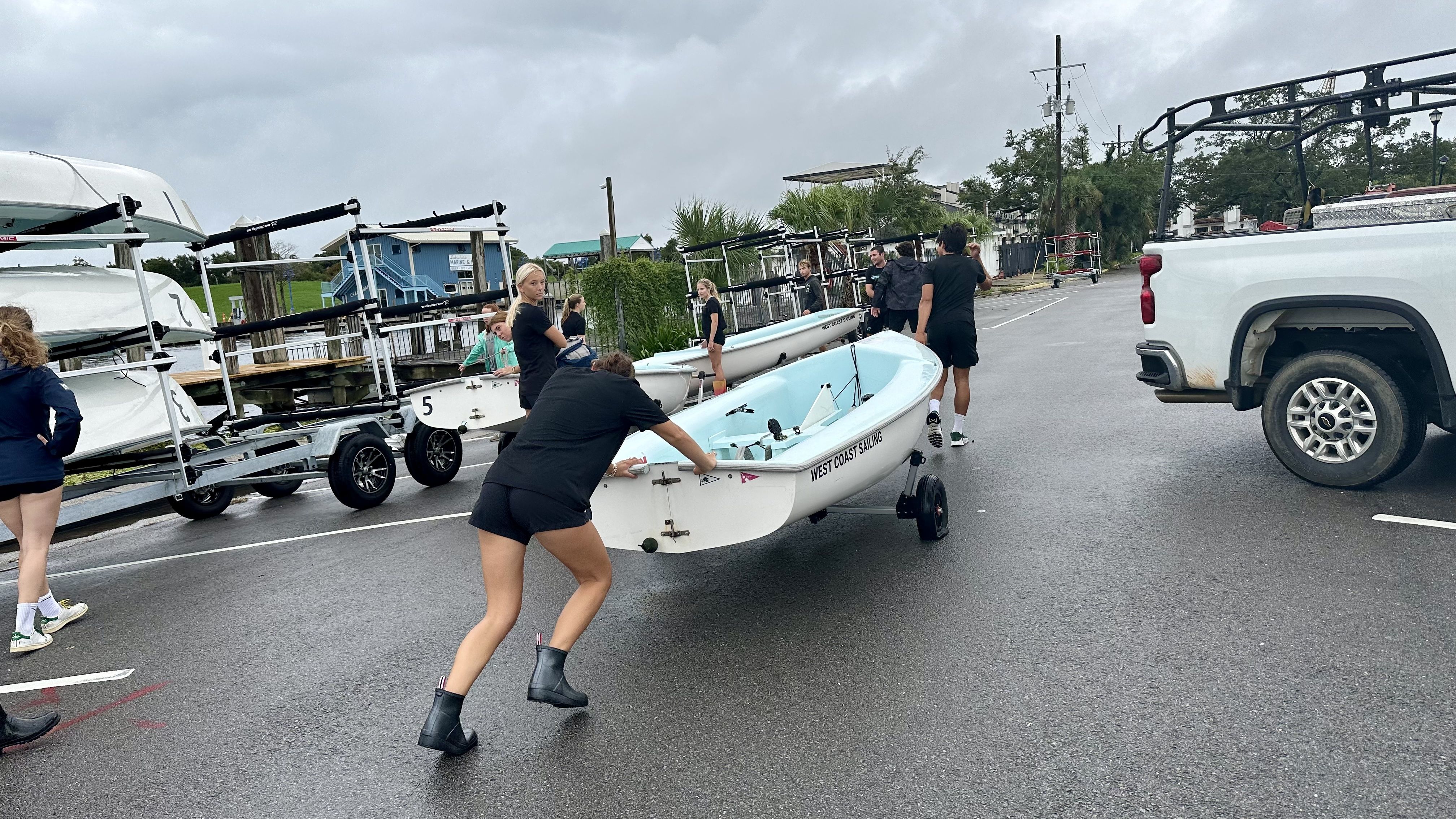 Photo shows people moving a boat.