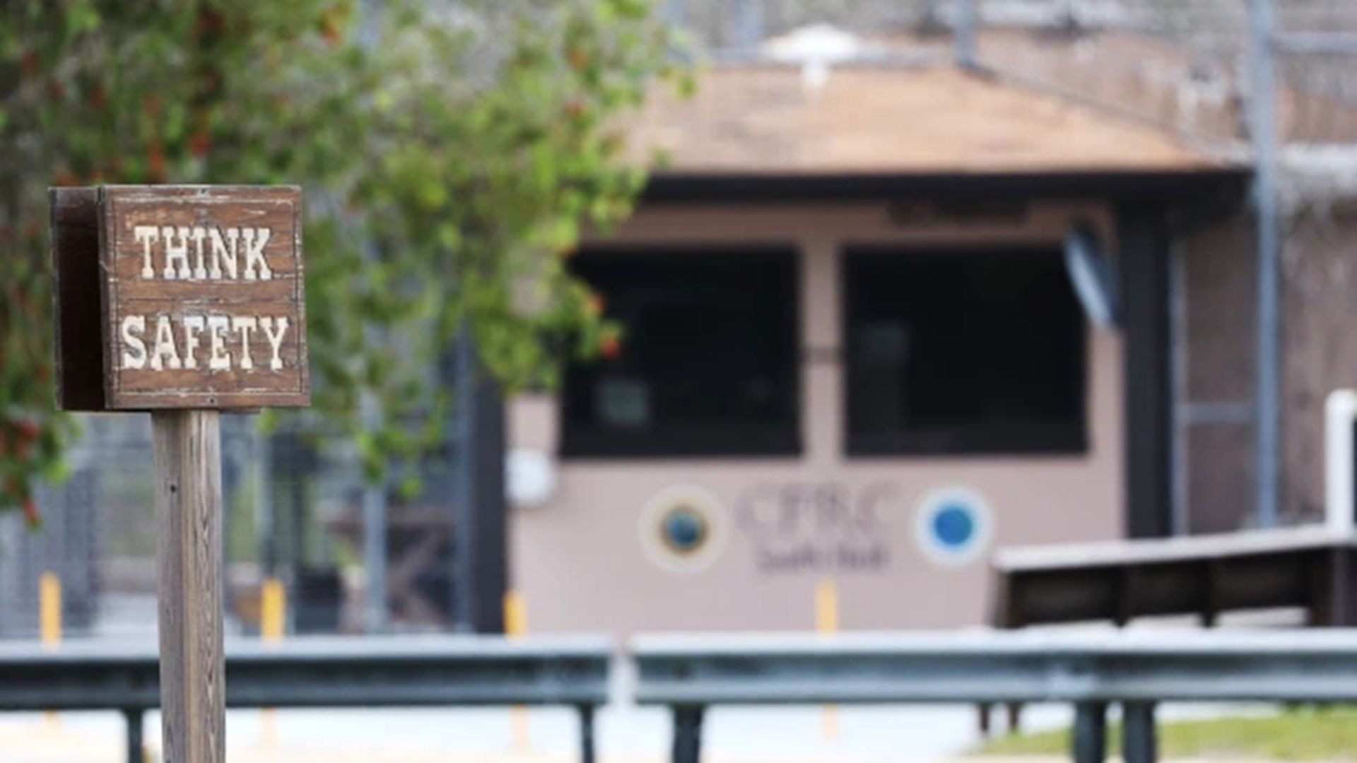 A hut at the entrance to a prison that reads, "Think safety."