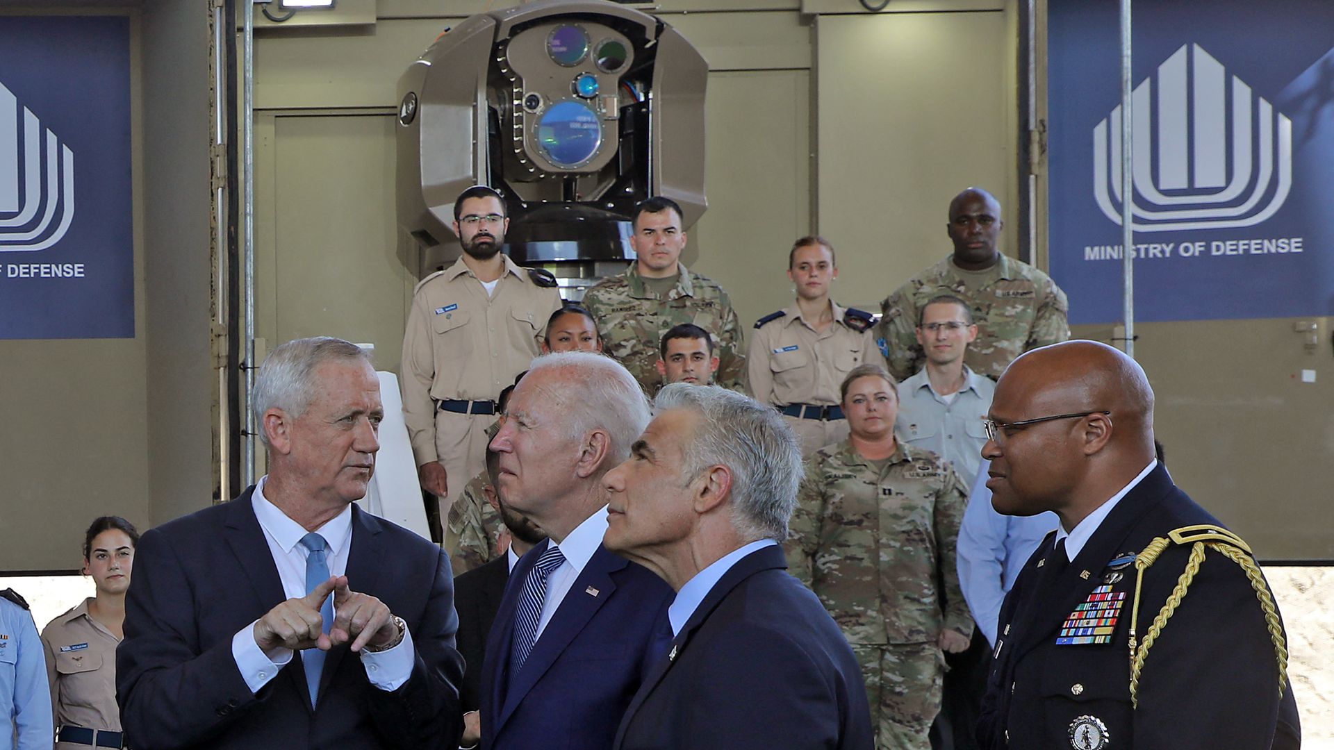 American and Israeli officials stand in front of an Iron Beam prototype.