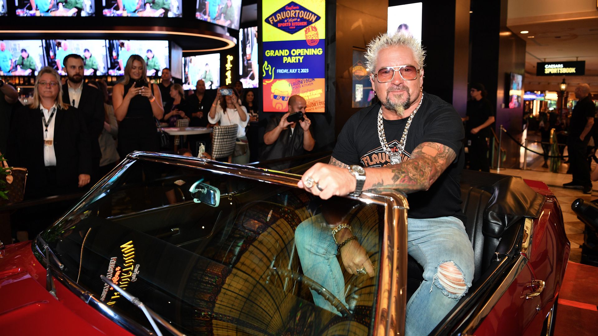 Guy Fieri poses in the iconic 1968 Chevrolet Camaro from his TV series "Diners, Drive-Ins and Dives." Photo: Denise Truscello/Getty Images for Caesars Entertainment