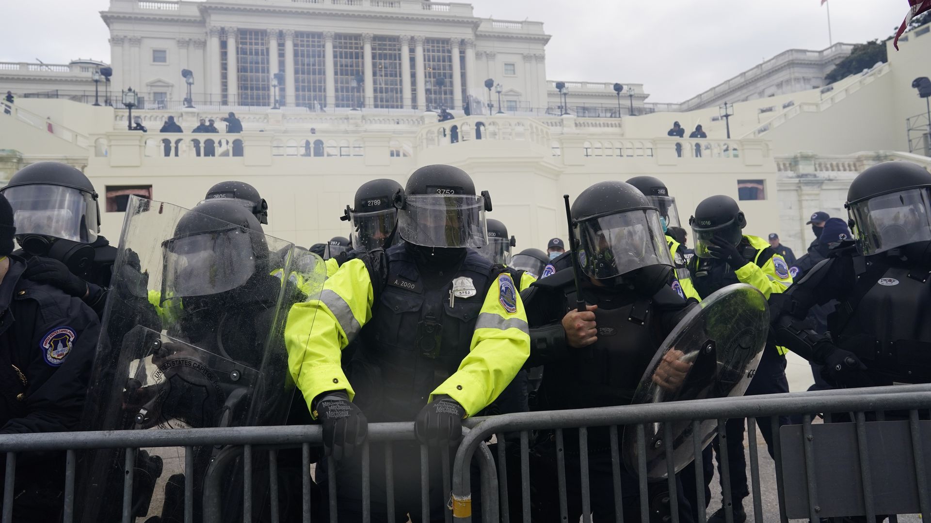 Capitol Police attempting to hold back people during the Jan. 6 riot at the U.S. Capitol.