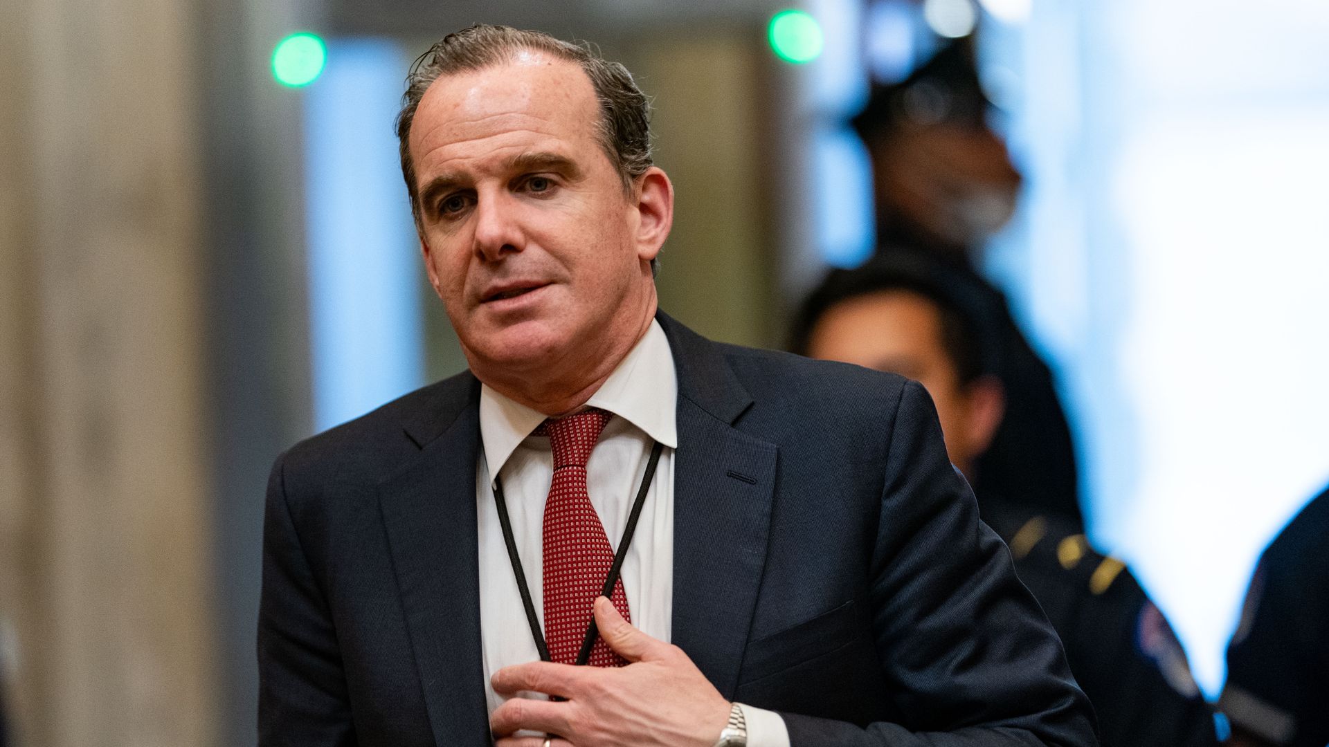 Brett McGurk, dressed in a dark suit with a white shirt and red tie.