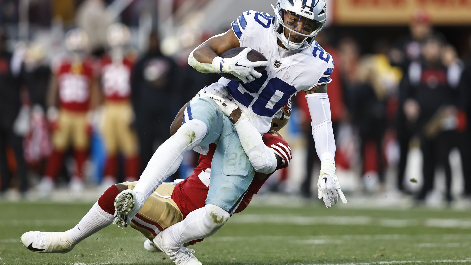 Tony Pollard being tackled in a way that injured his lower left leg