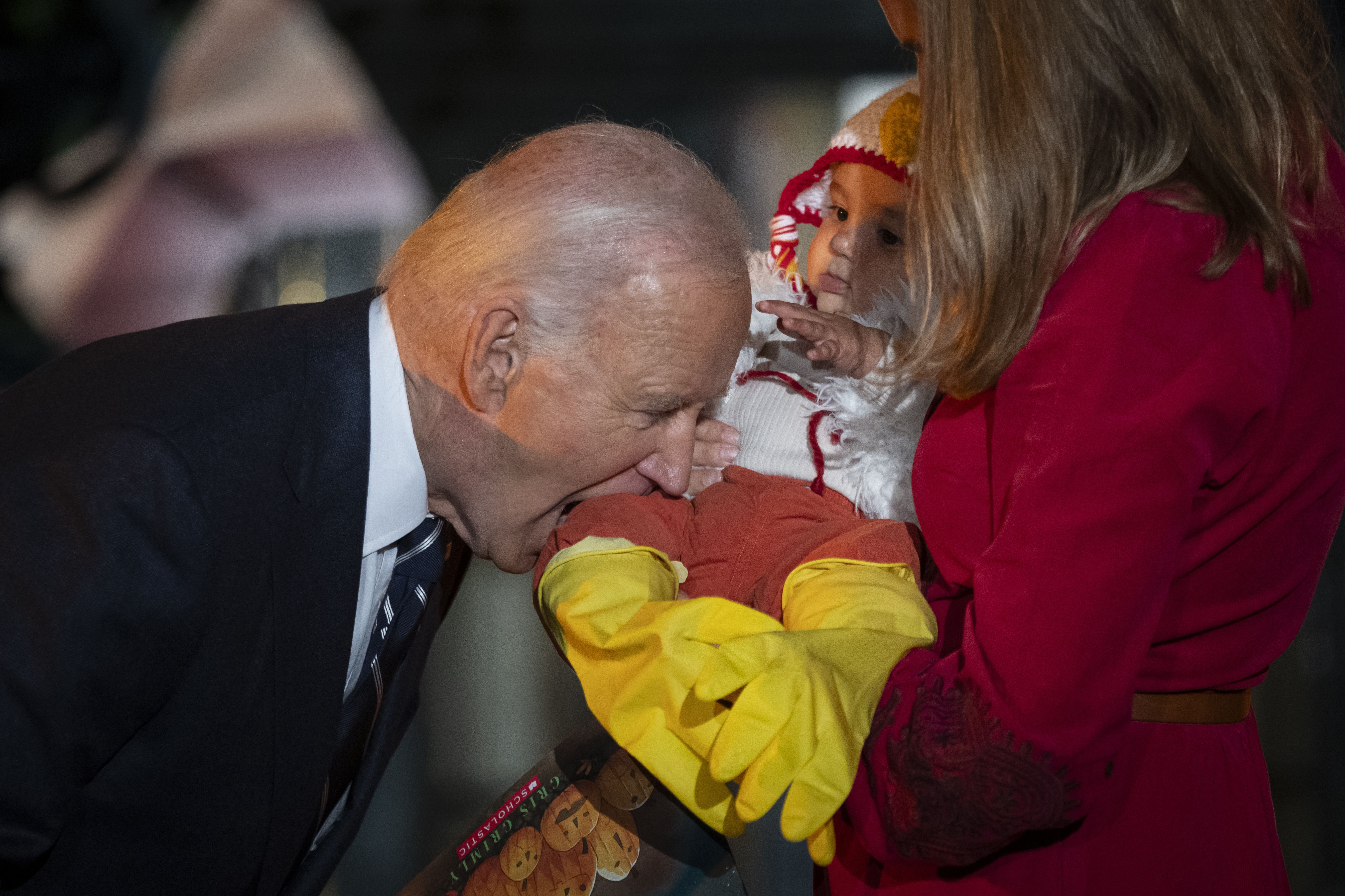 President Joe Biden joking bites the leg of a baby on the South Lawn last night.