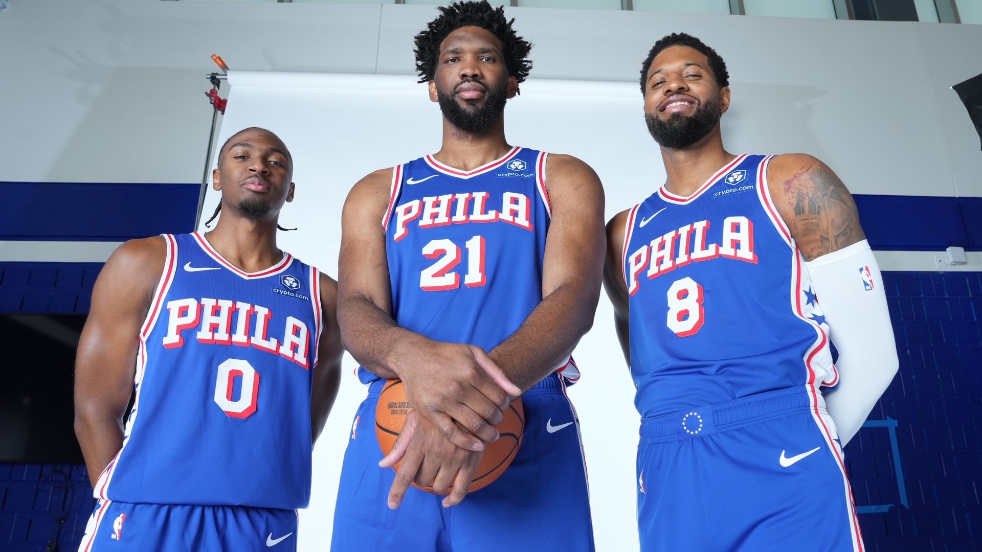 The Sixers' Tyrese Maxey , left, Joel Embiid, middle, Paul George.