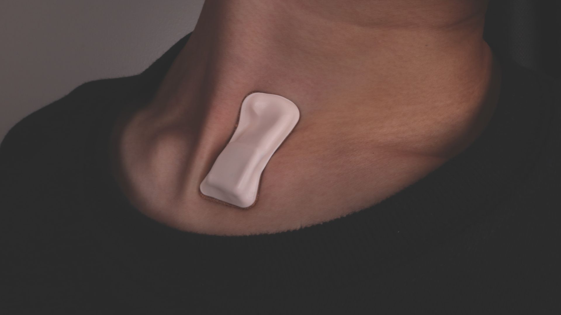 In this image, a small patch is worn on a neck