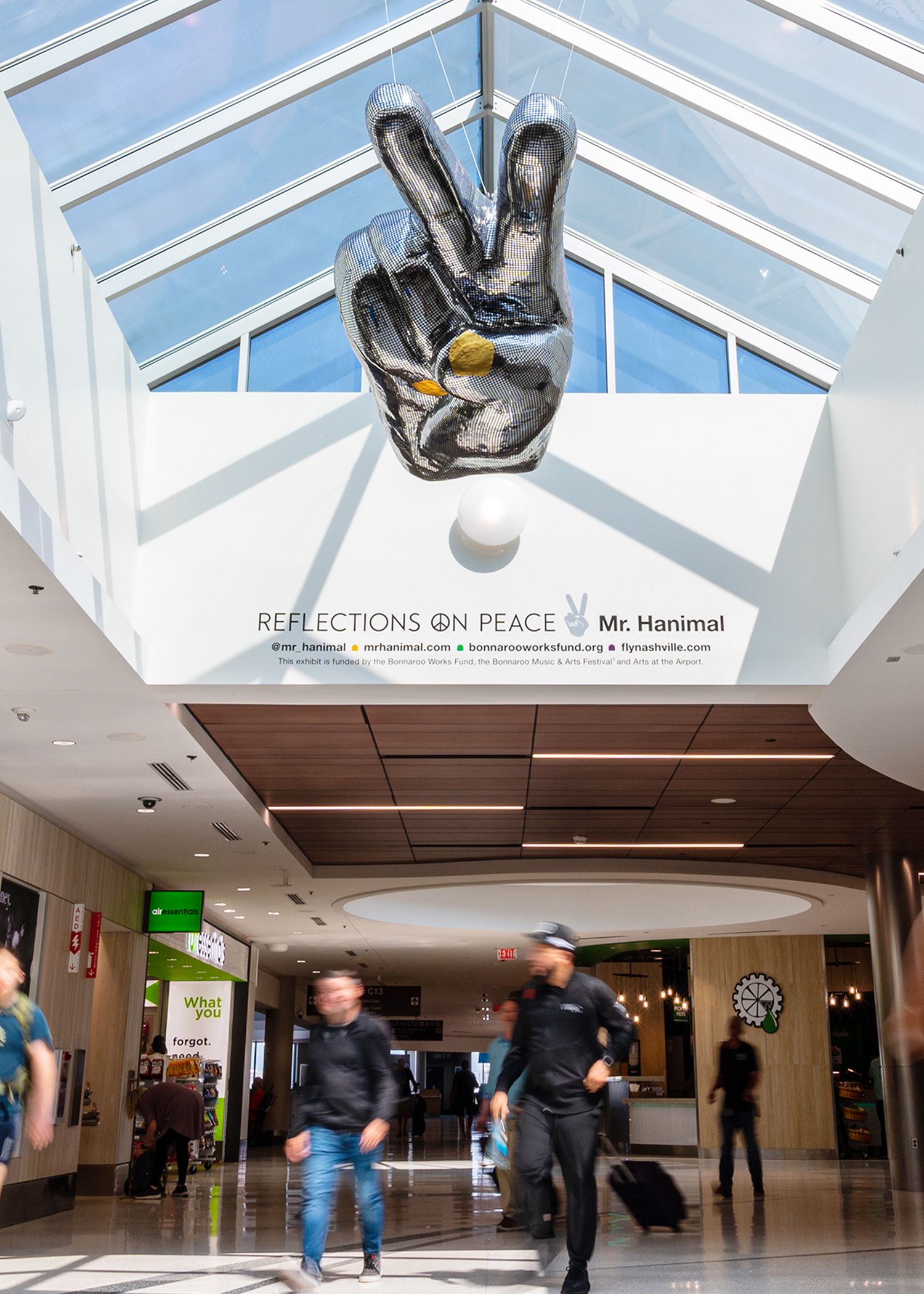 A sculpture of a large mirrorball hand.
