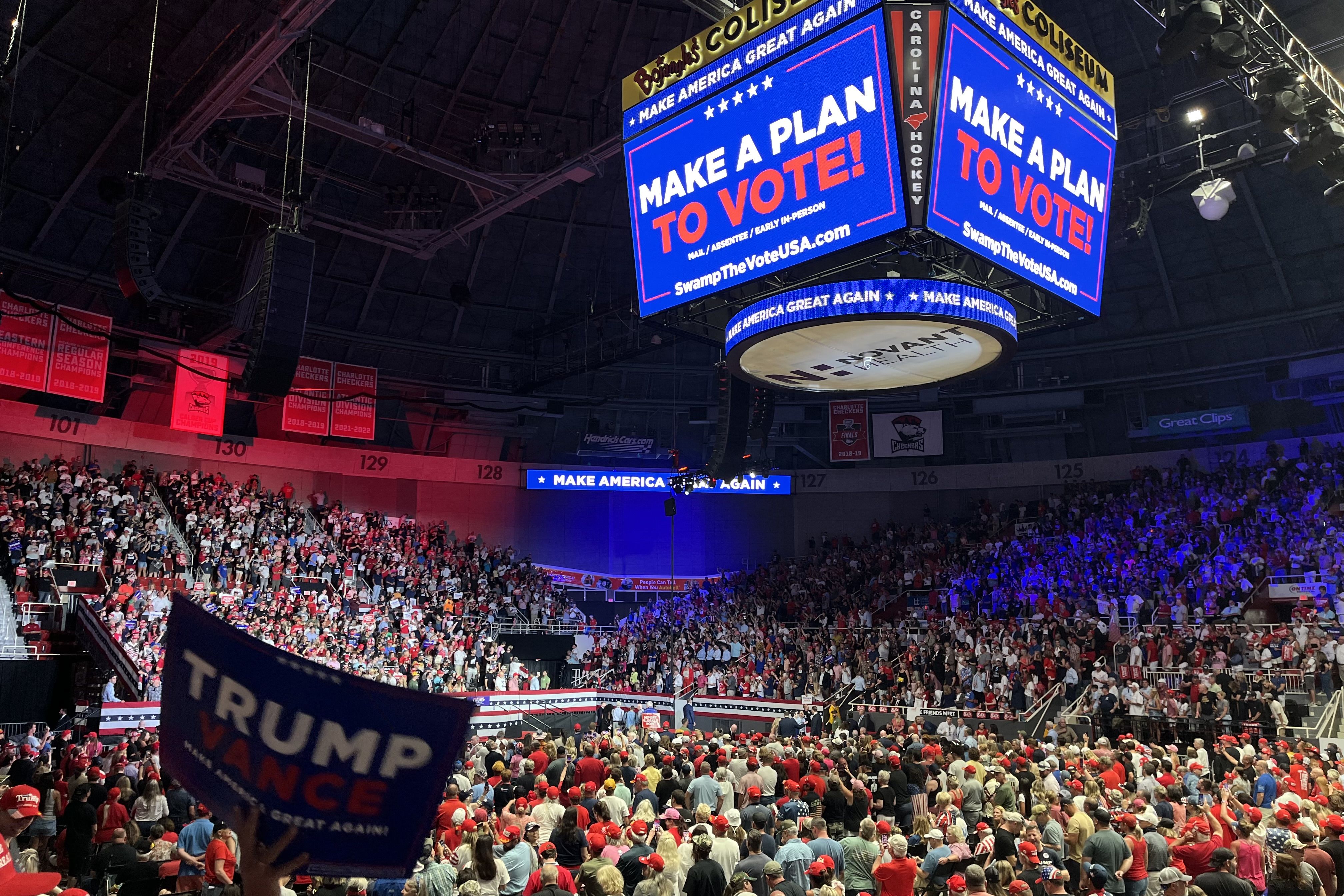Trump Vance sign in front of large crowd