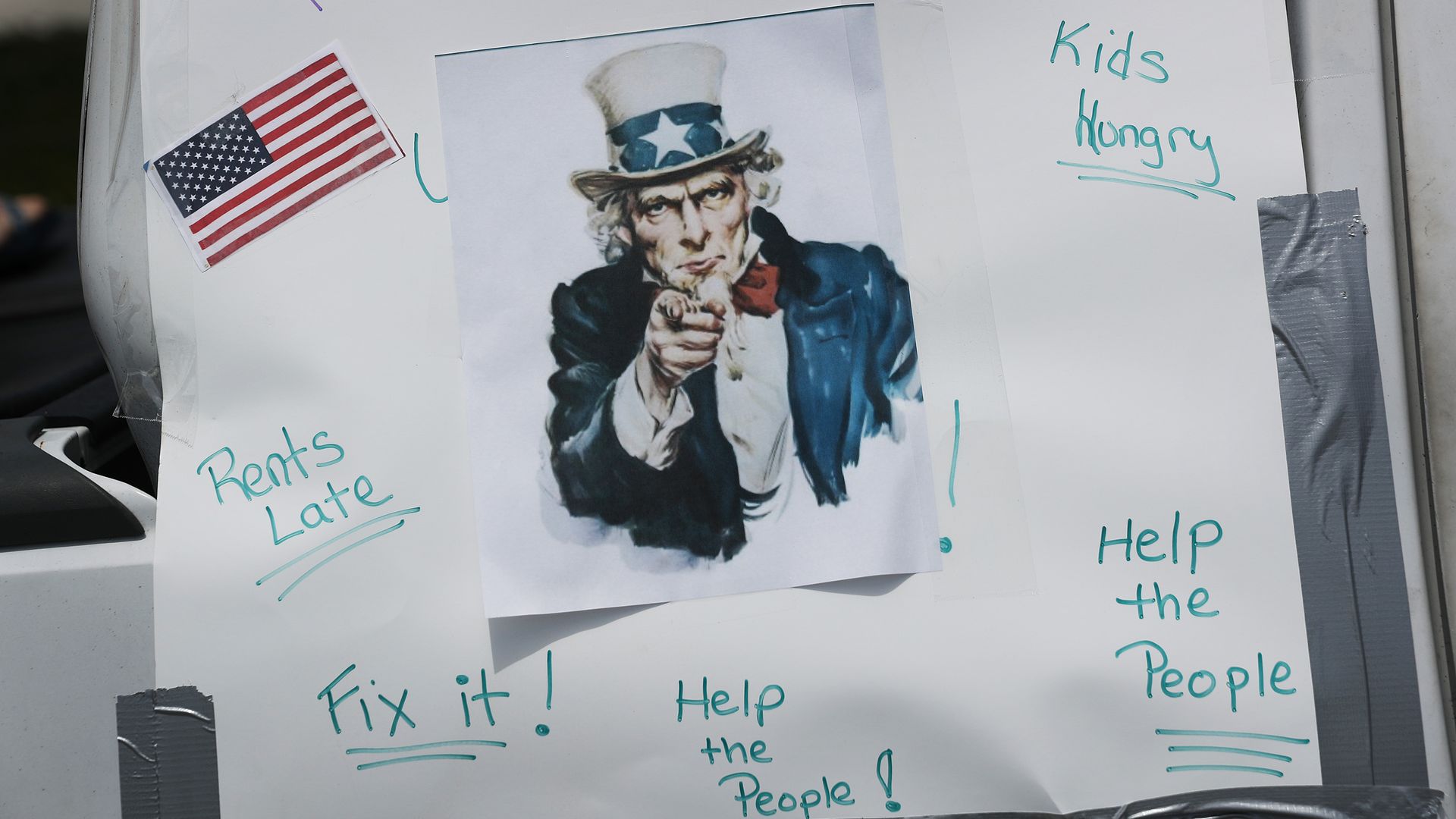 A sign urging leaders to fix unemployment.