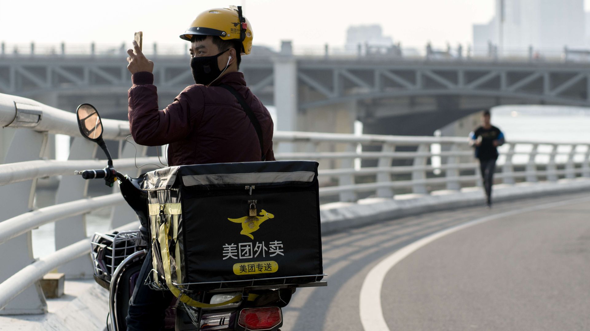 Chinese delivery guy on motorbike