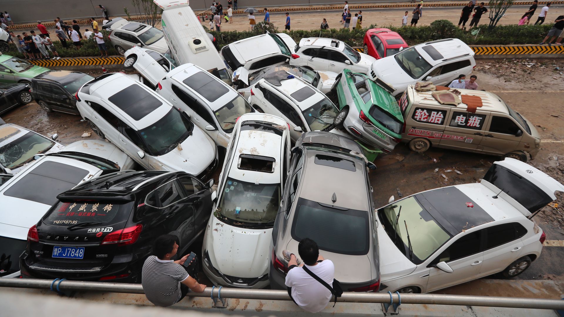Damaged cars that were swept away by floodwaters piled on an expressway on July 22 in Zhengzhou, China.