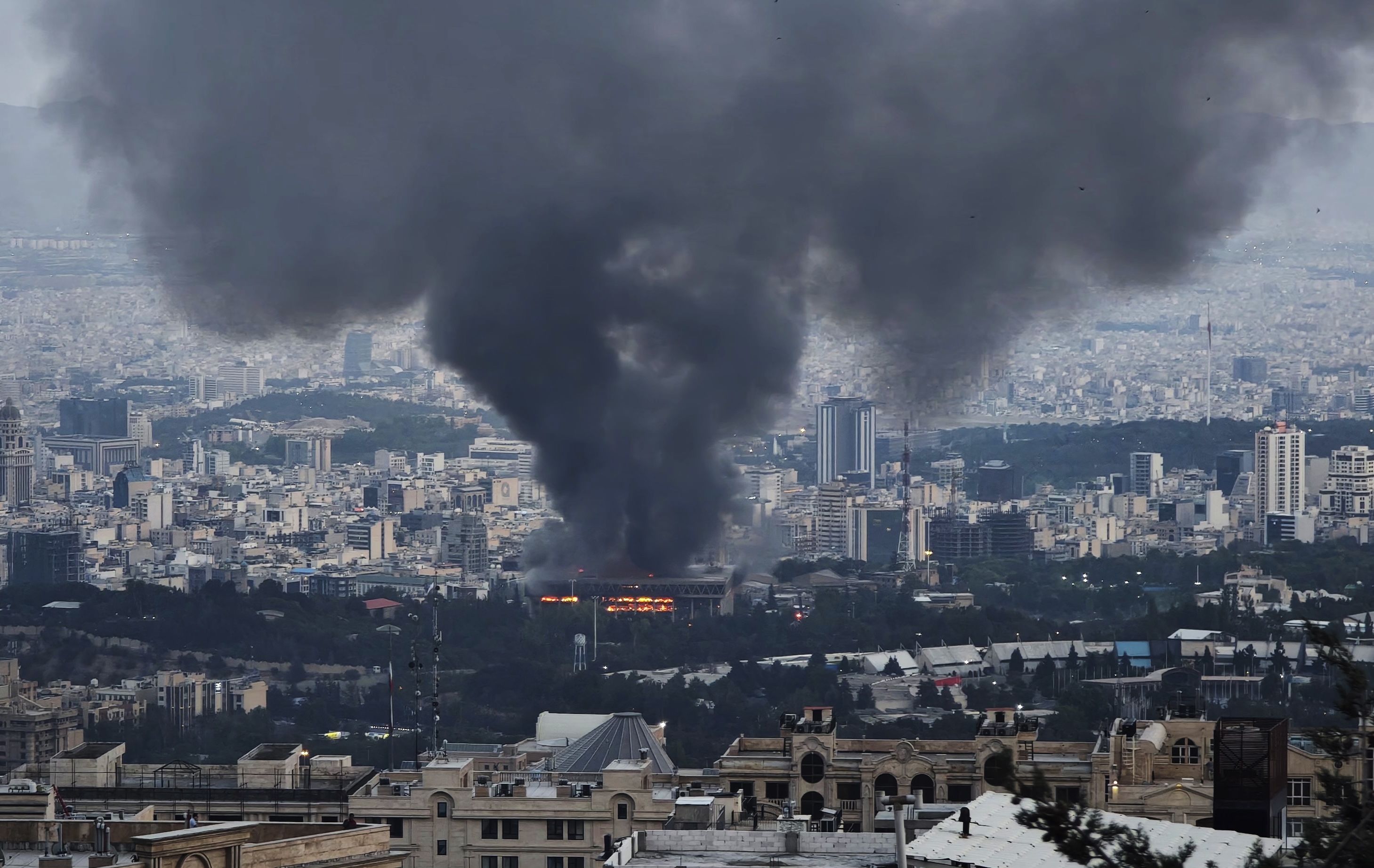 Smoke rises after the IDF attacked Iran's state TV studios in Tehran yesterday.
