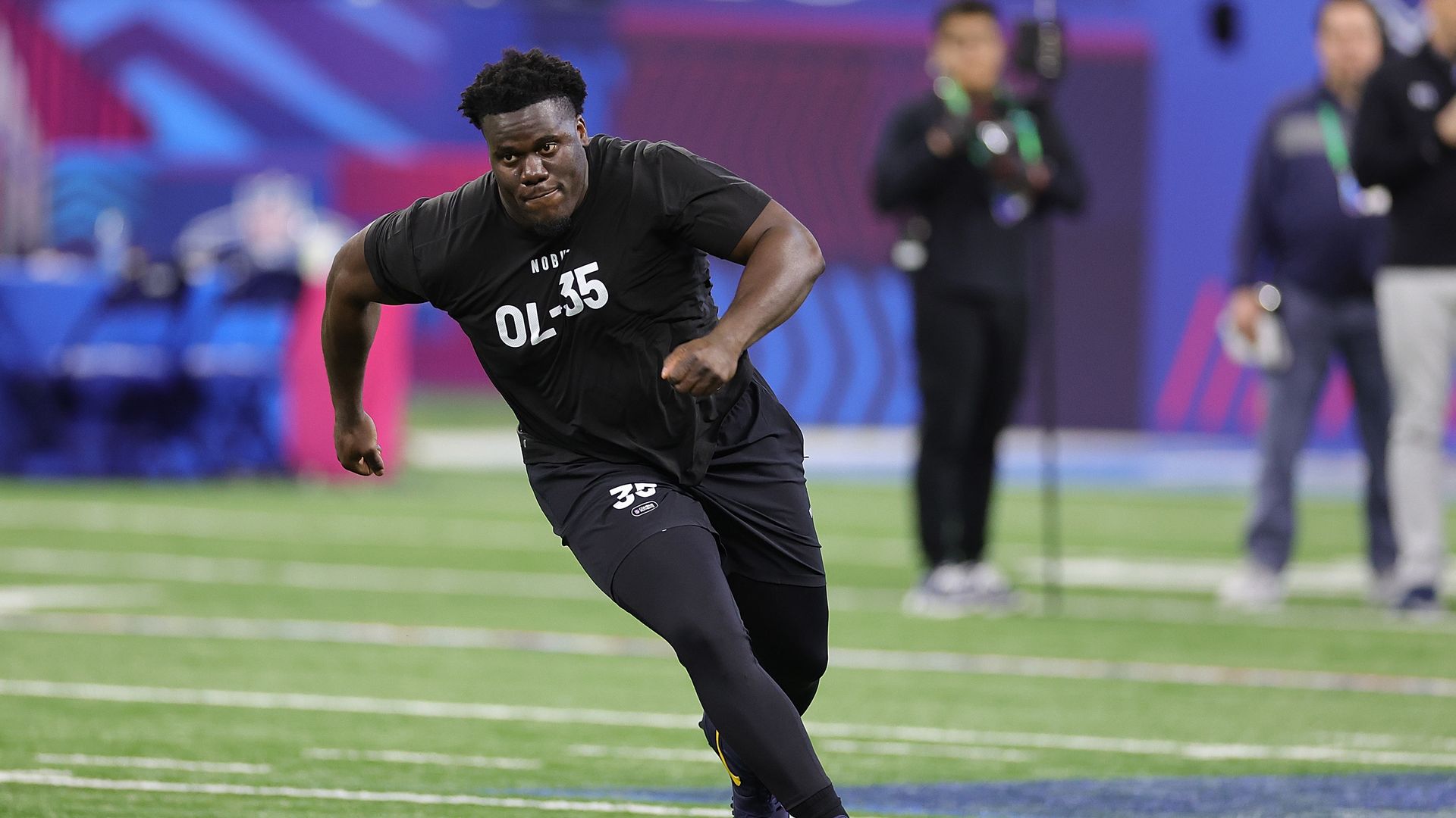 Football player running drills. 