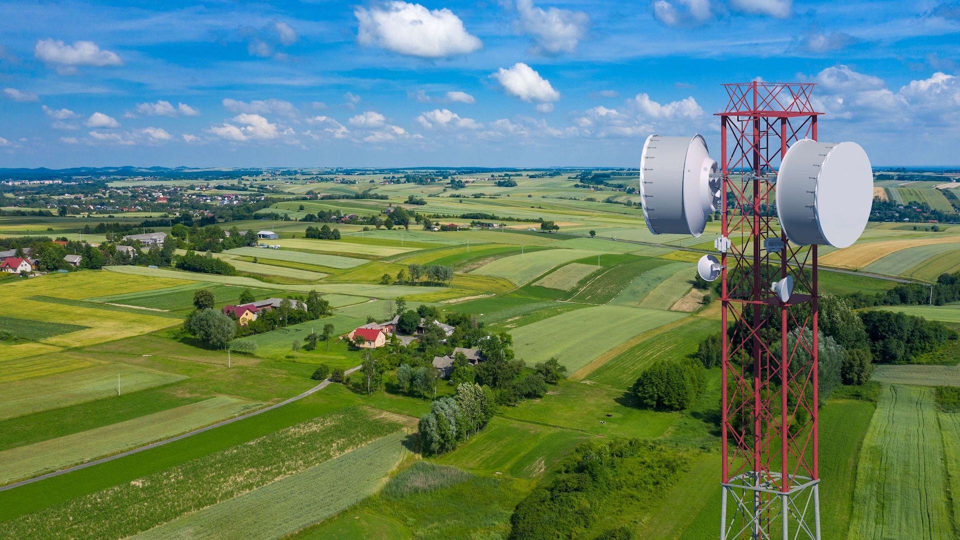 There are green fields and a blue sky. A right satellite is on the right of the image.