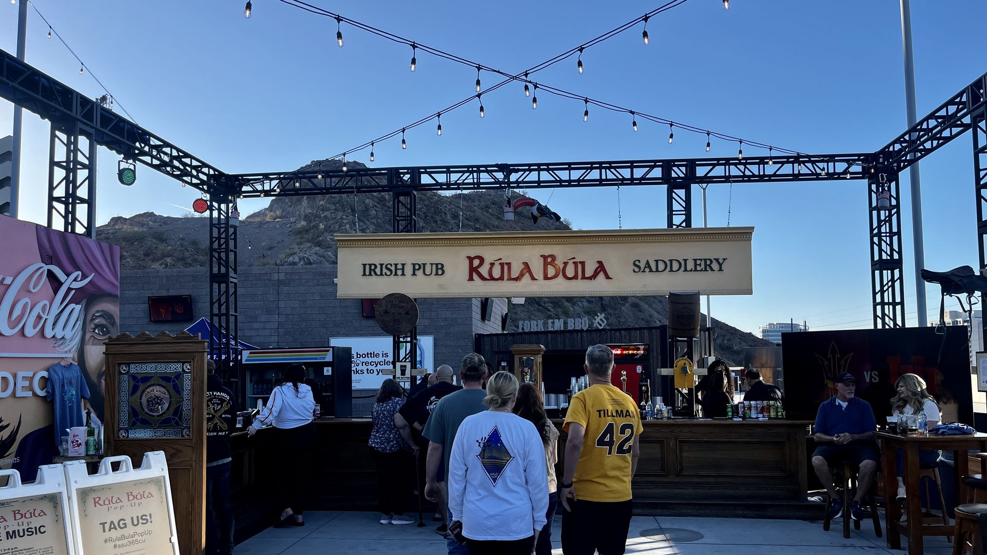 An outdoor bar with a sign that says, "Rula Bula." 