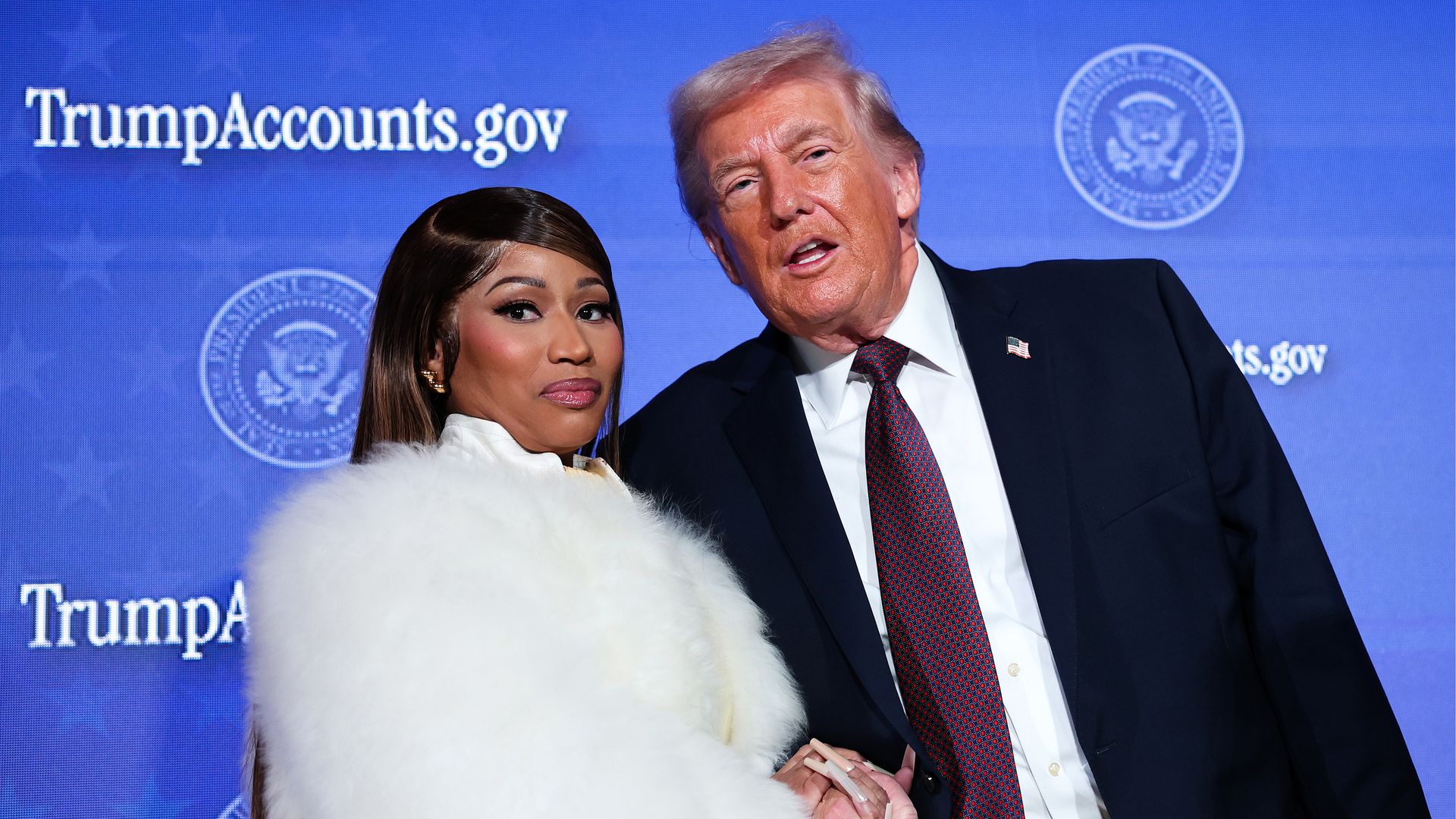Nicki Minaj joins Donald Trump on stage as he delivers remarks during the Treasury Department's Trump Accounts Summit at Andrew W. Mellon Auditorium on January 28, 2026 in Washington, DC.