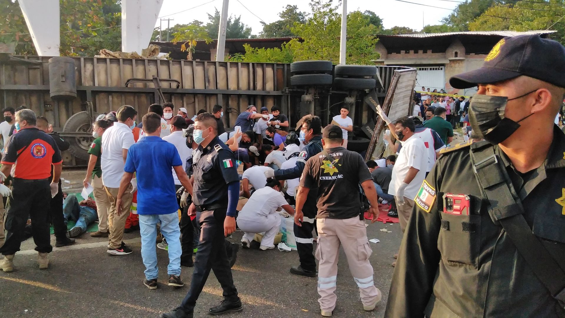 Photo of Mexican police and rescue workers at the scene of a truck crash