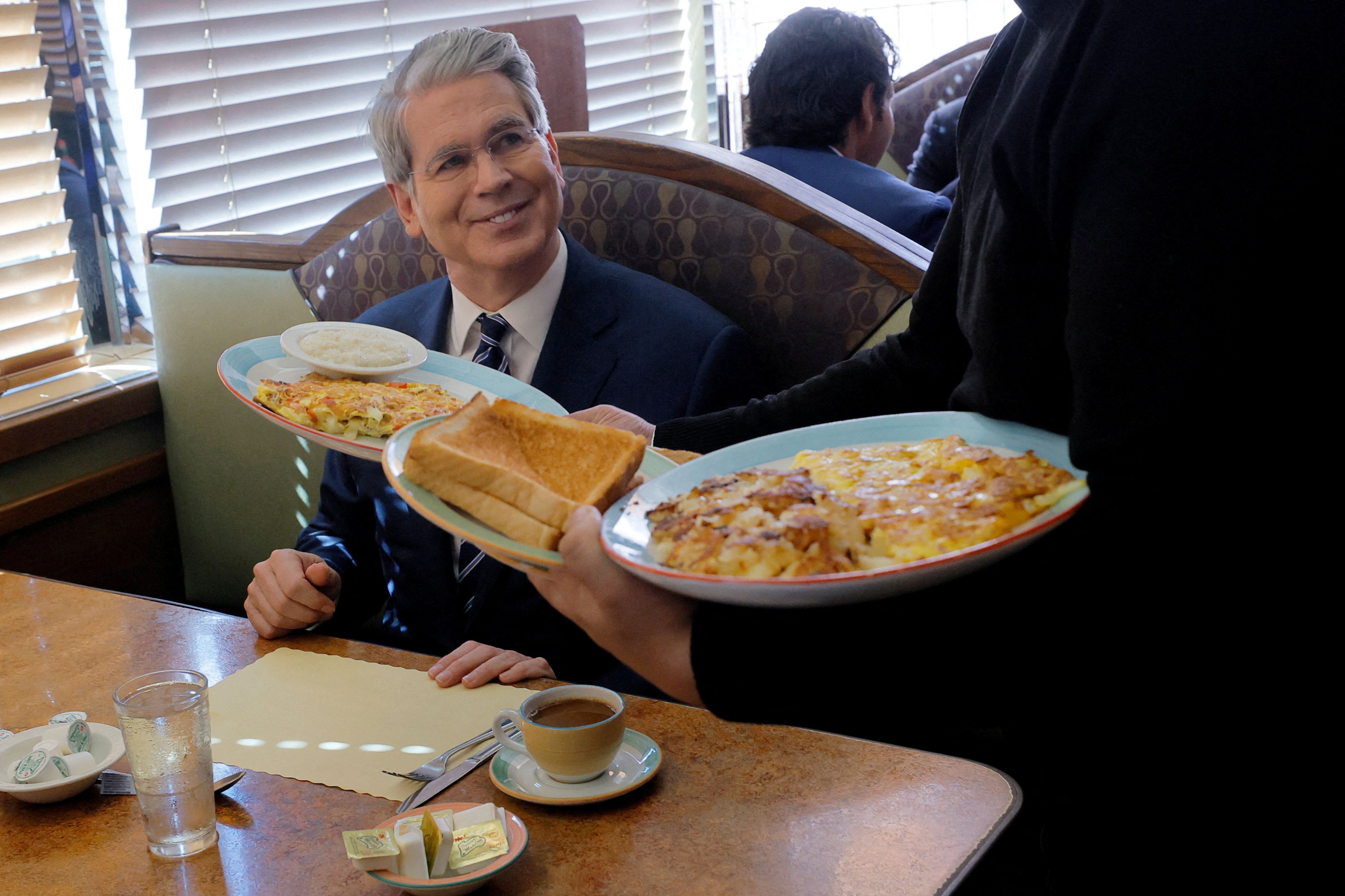 U.S. Secretary of the Treasury Scott Bessent watches as his food order is served during a Labor Day visit to Metro 29 Diner in Arlington, Virginia, U.S., September 1, 2025. REUTERS/Brian Snyder