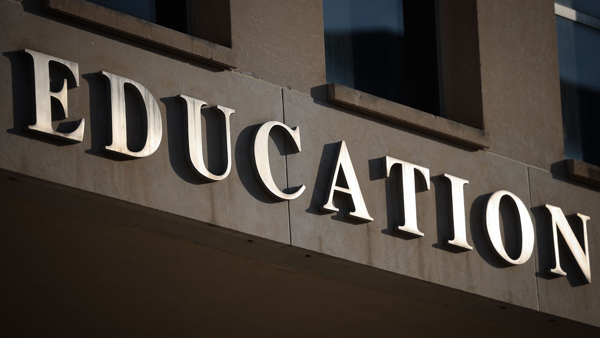 The word "EDUCATION" is sprawled across a brown building.