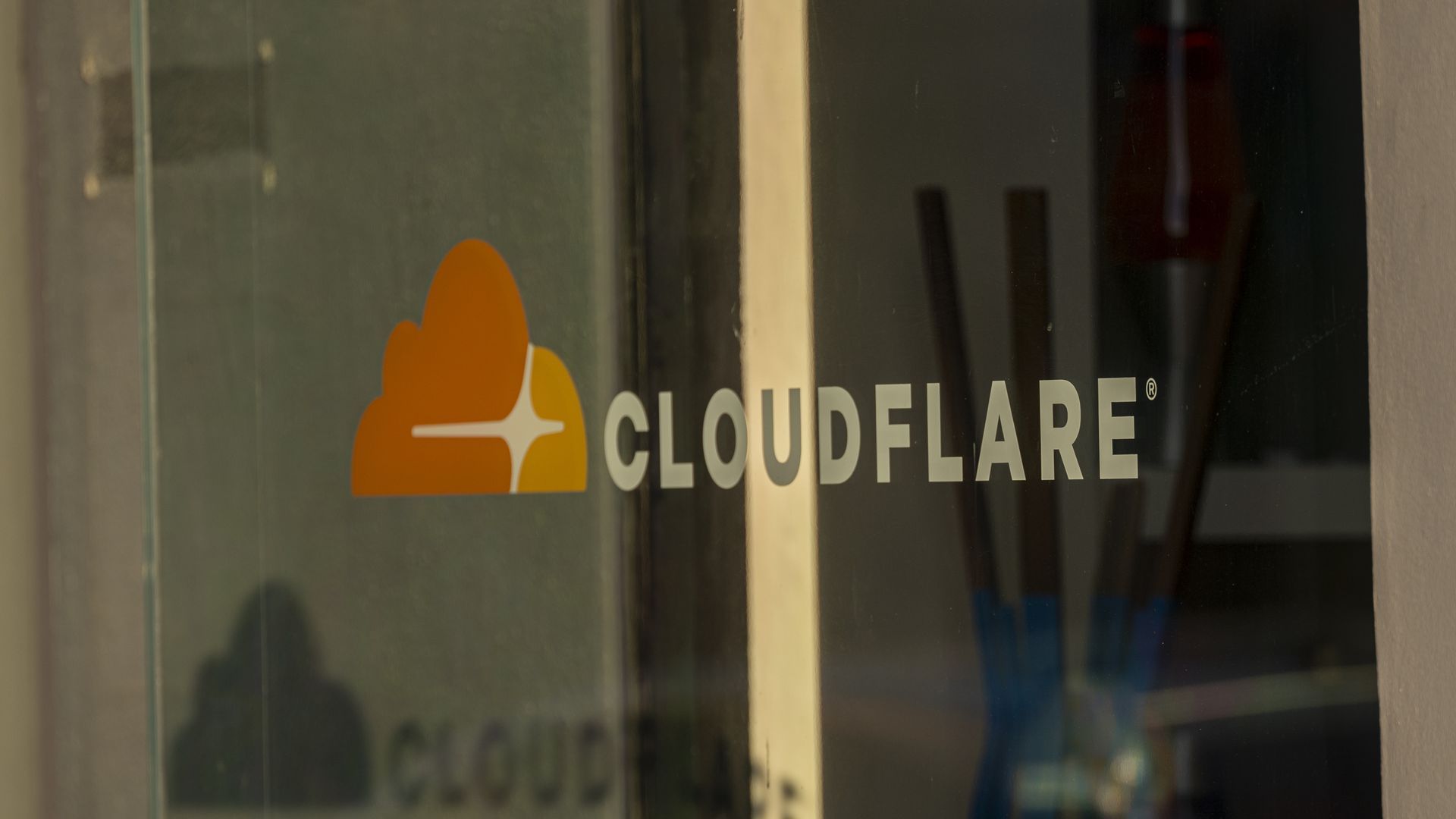 The Cloudflare logo on an office window