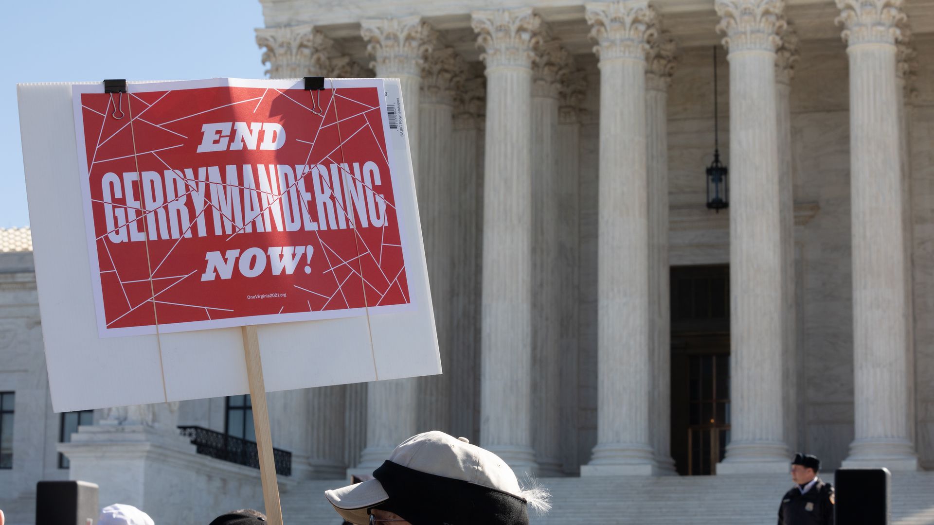 A protester waves a "Stop gerrymandering now" sign outside the Supreme Court