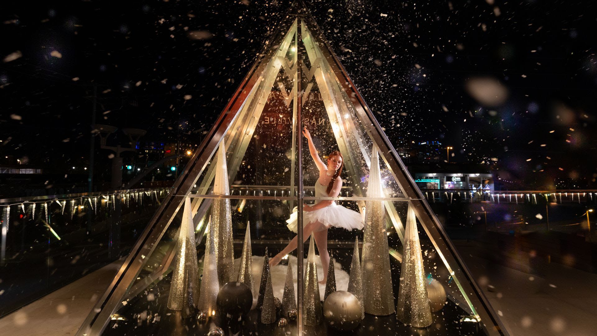 A performer dances in a glass triangle at the W hotel 