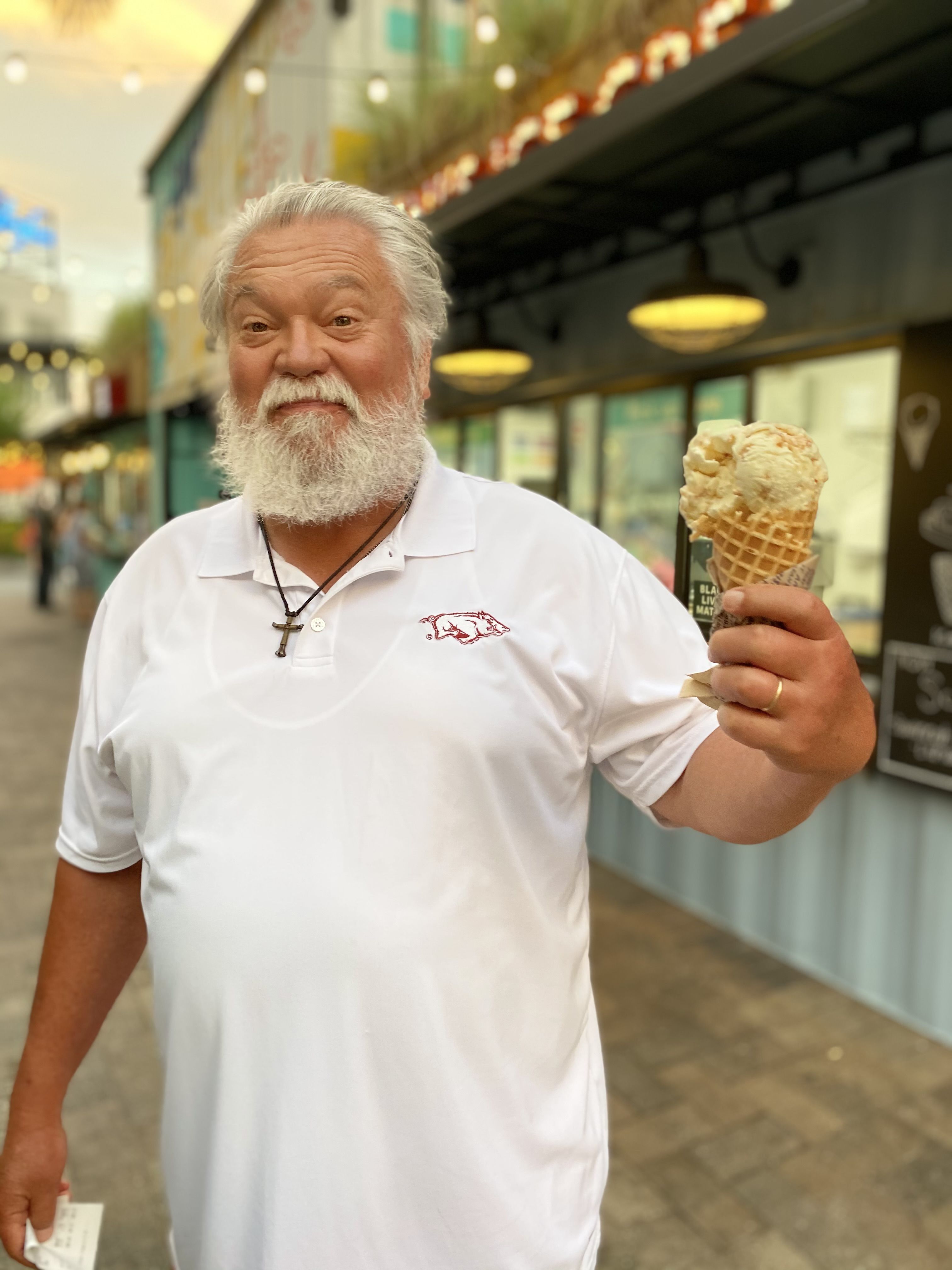 A Razorback fan holds an ice cream cone at Sparkman Wharf.