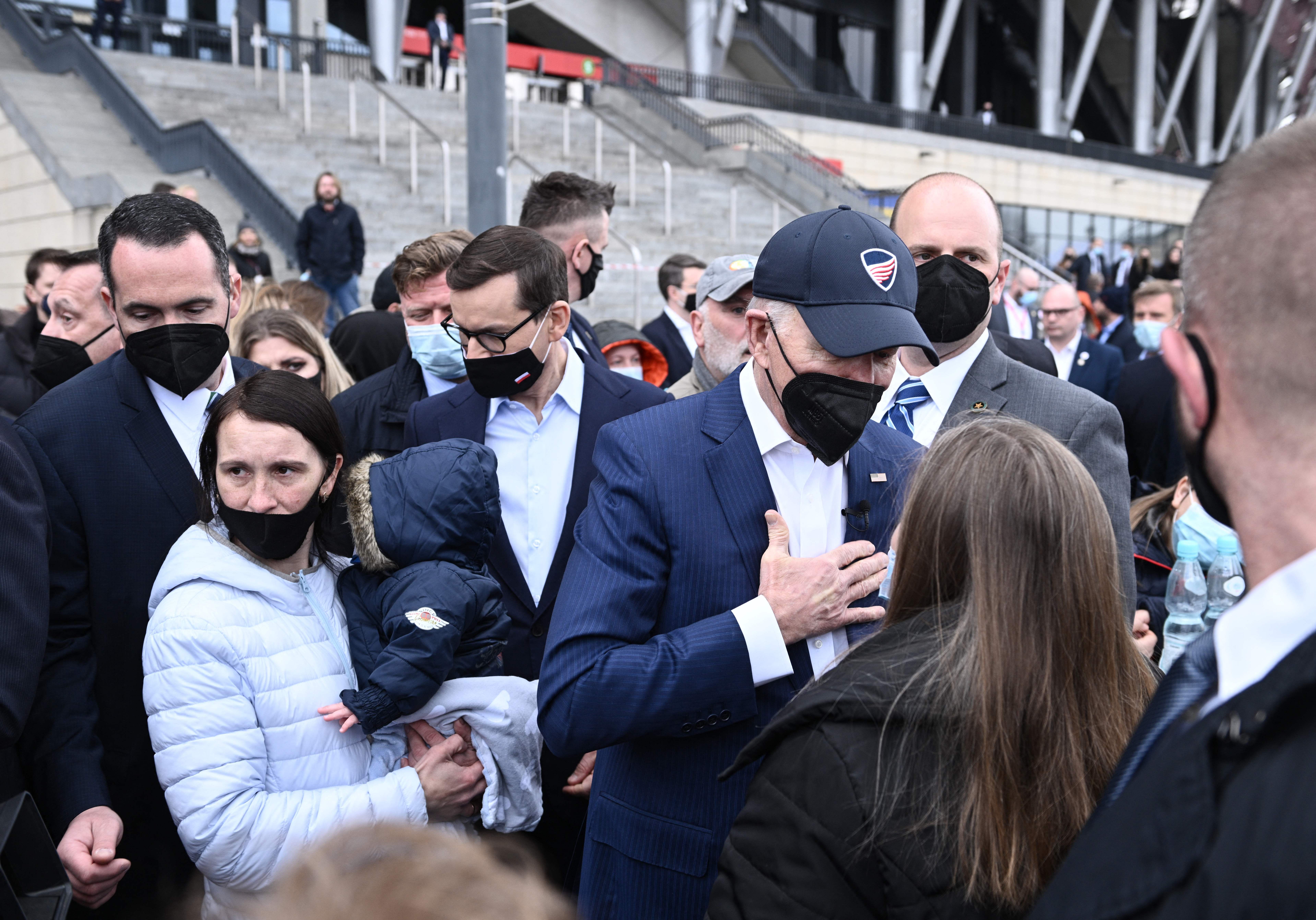 President Joe Biden and Polish Prime Minister Mateusz Morawiecki greet Ukrainian refugees at PGE Narodowy Stadium in Warsaw on March 26, 2022