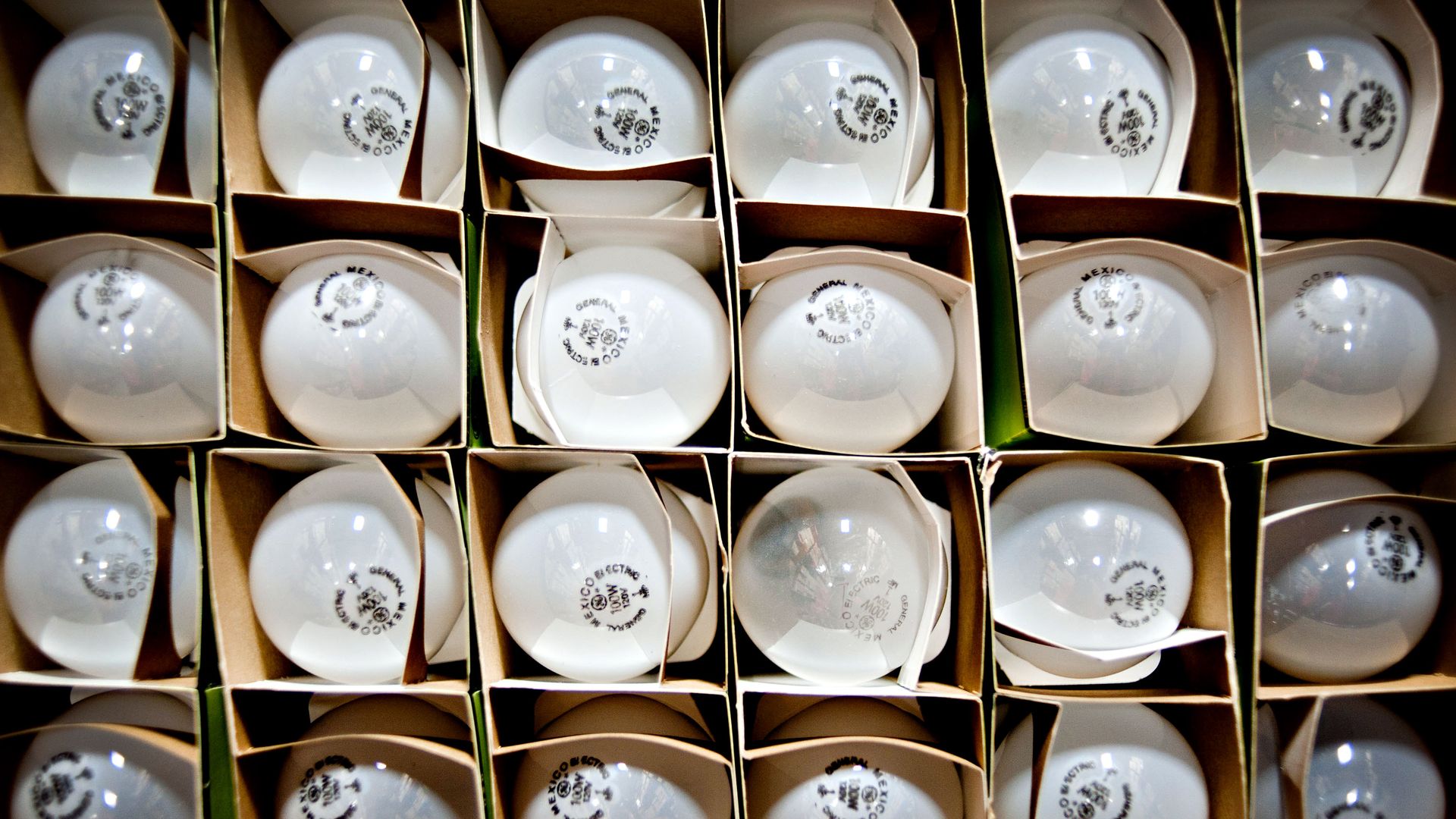 General Electric Co. 100-watt incandescent bulbs sit on a shelf at the Kennedy Webster Electric Co. warehouse in Downers Grove, Illinois, U.S., on Tuesday, July 19, 2011.