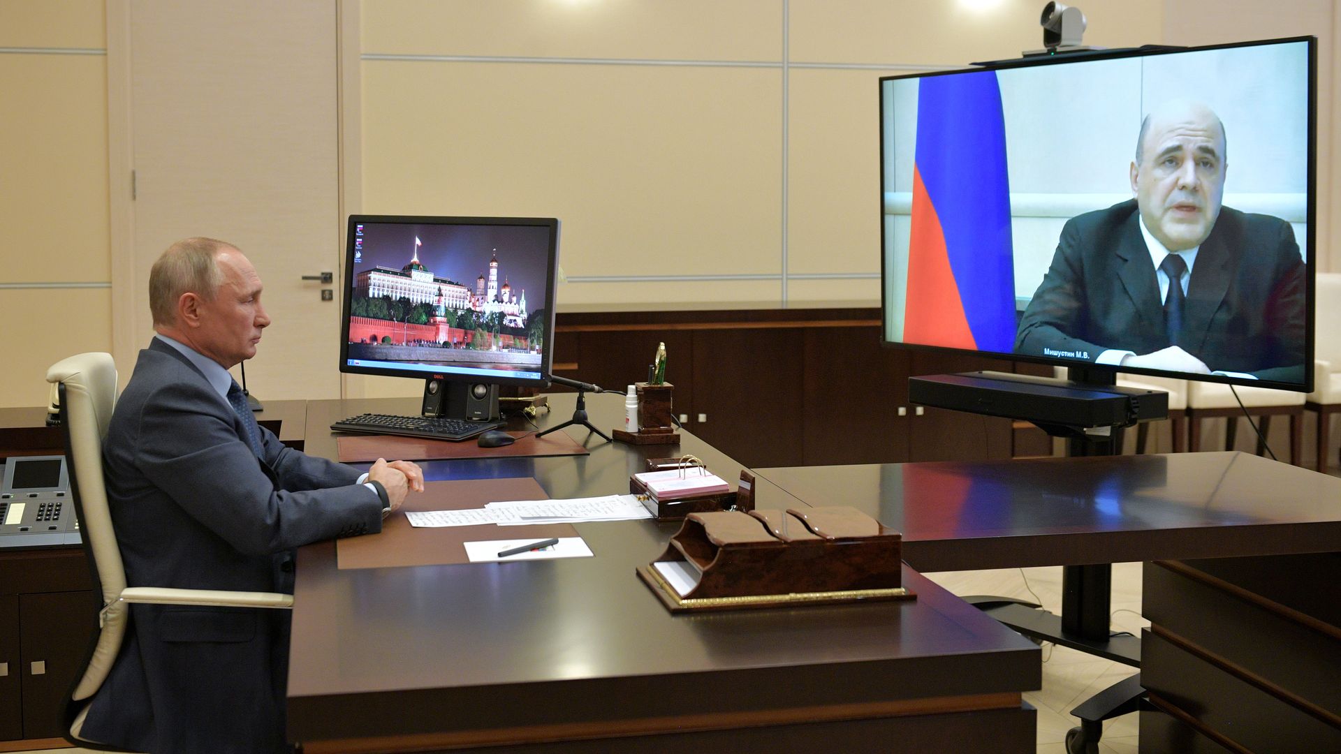 In this image, Putin and the prime minister have a telemeeting