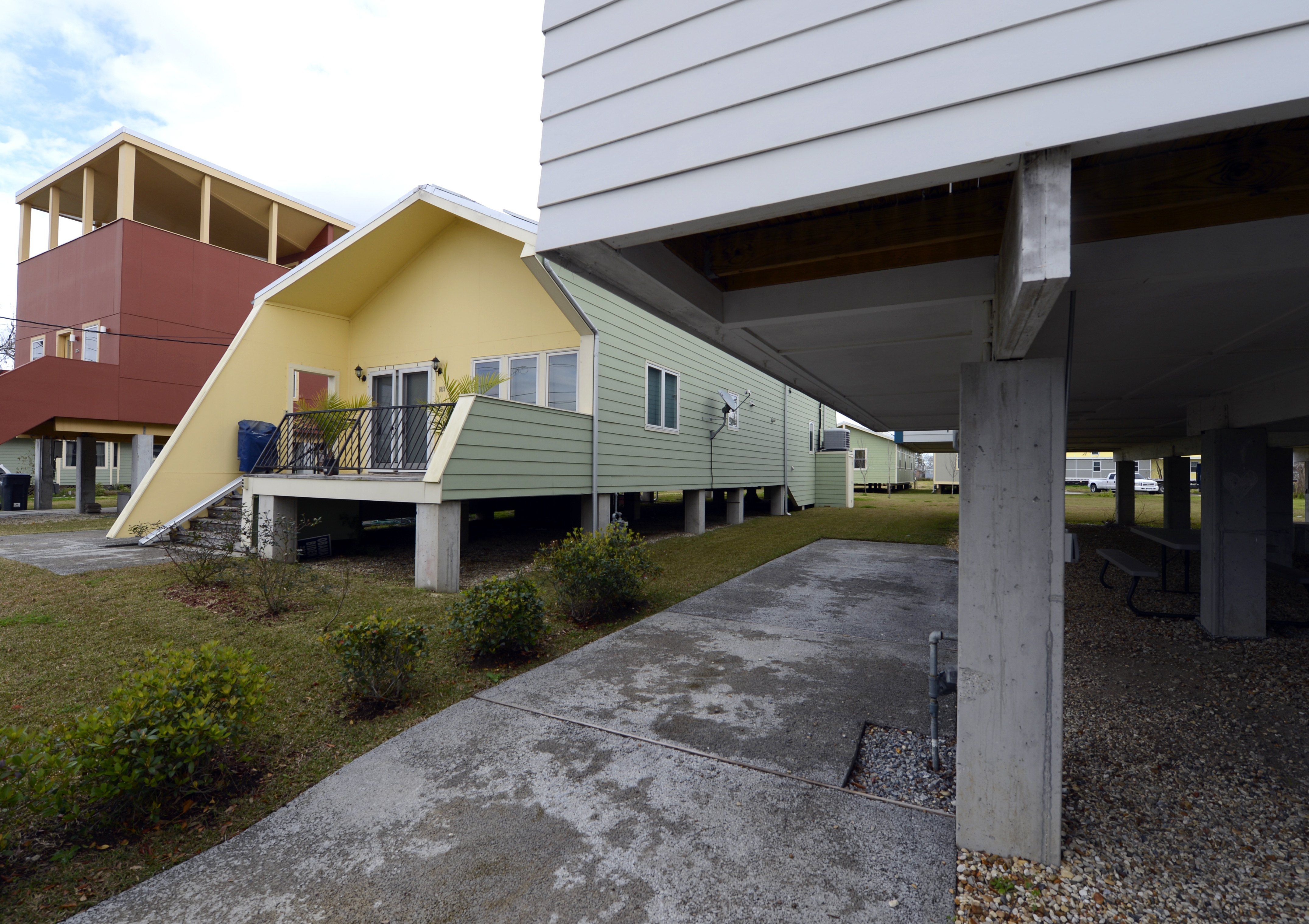 A yellow and green modern home sits in the Lower Ninth Ward.
