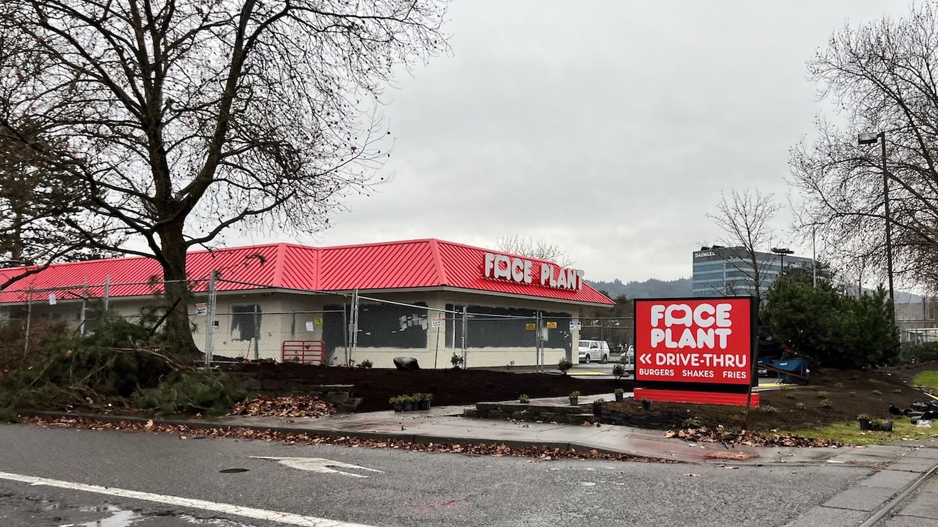 A photo of the outside of a drive-thru restaurant with the name "Face Plant"