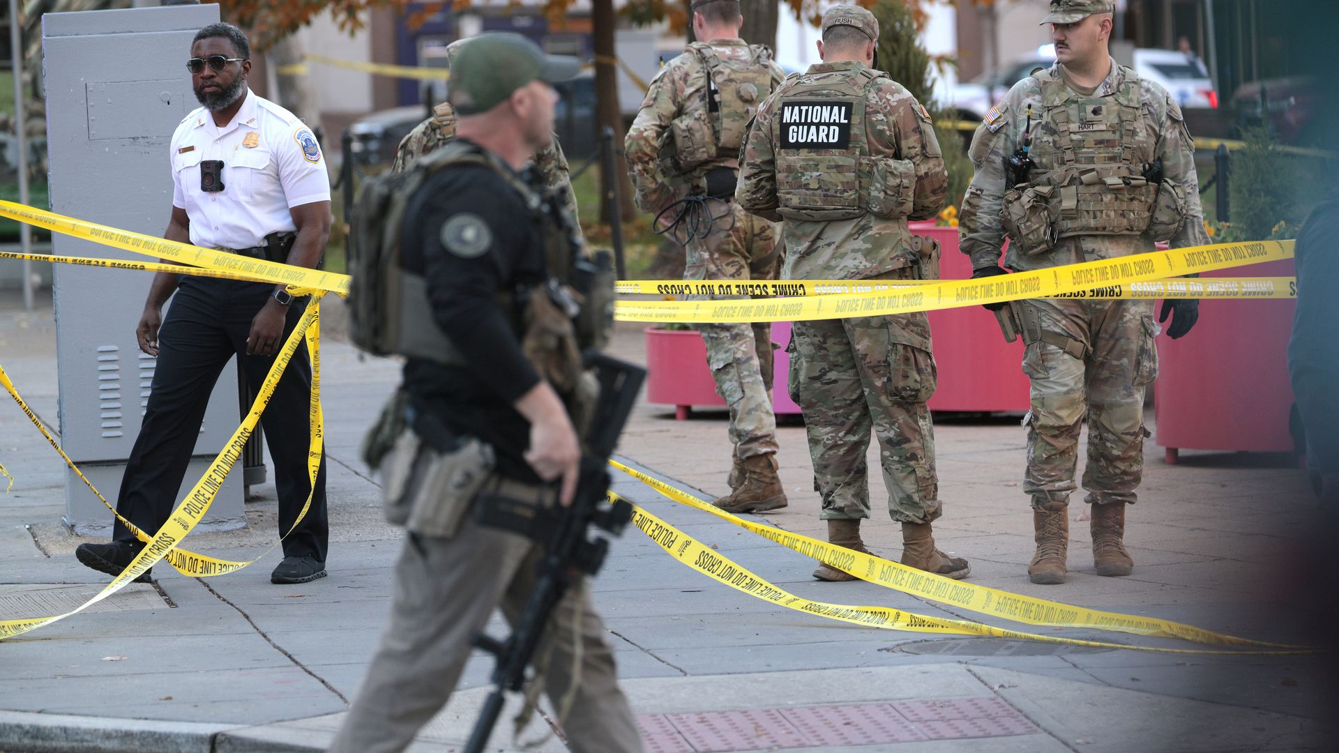 National Guard and other law enforcement seen on a sidewalk with caution tape 