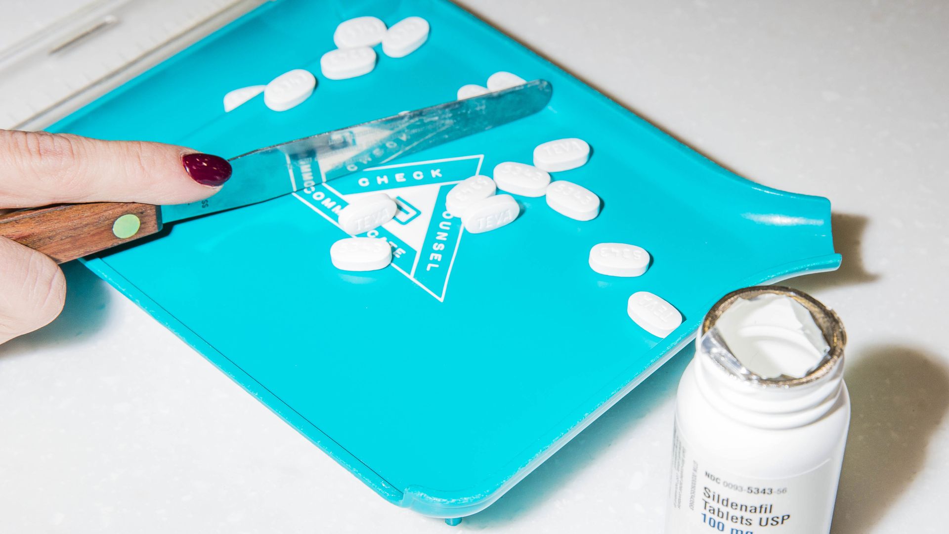 Drug tablets on a pharmacist sorting dish.