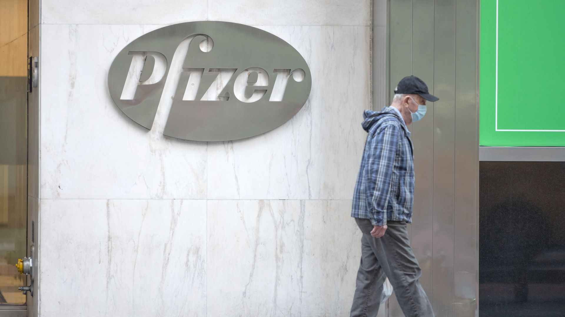 A man walks by the Pfizer building 