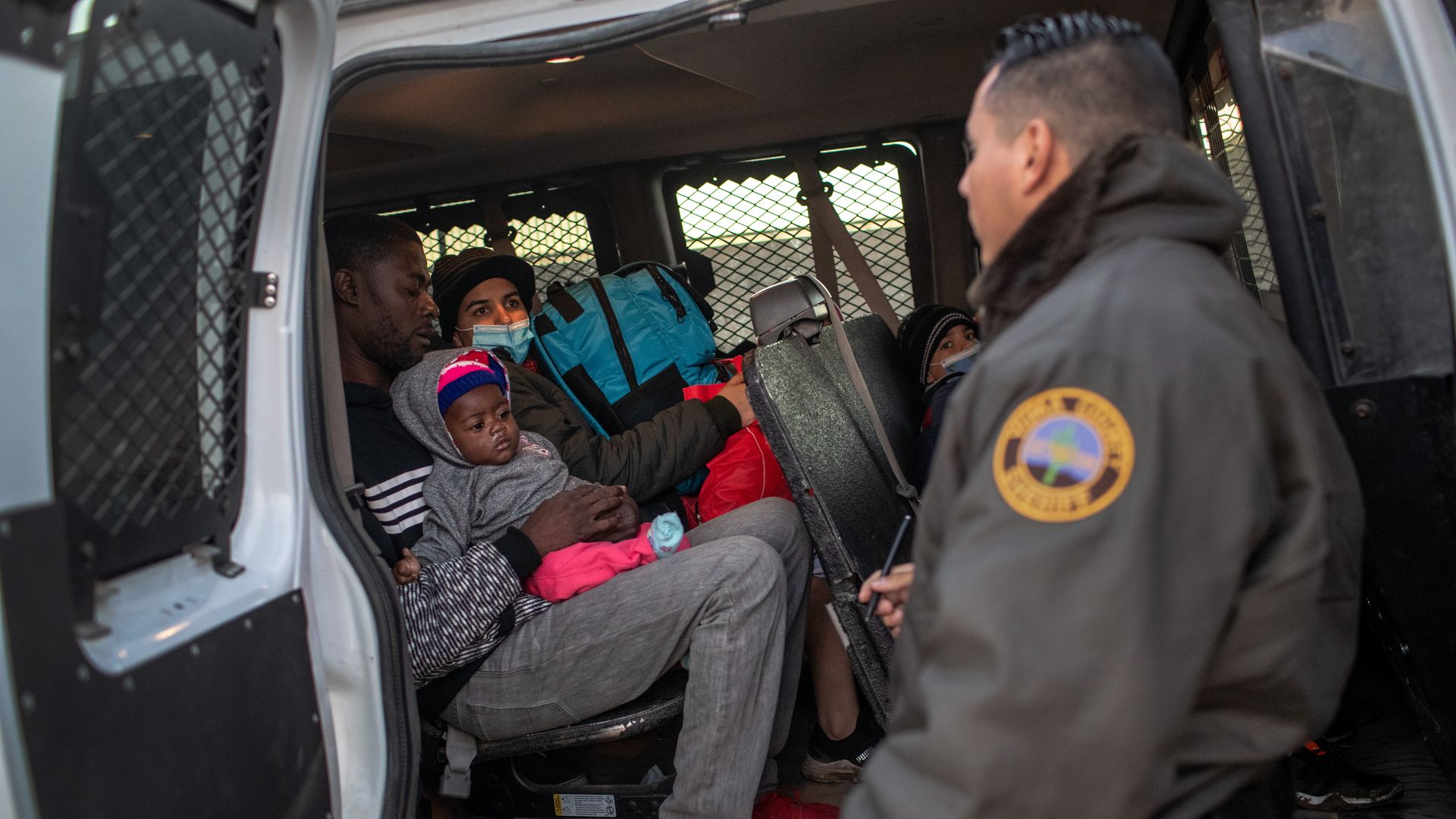  Immigrants from Haiti and Venezuela await transfer by sheriff's deputies to a U.S. Border Patrol processing center 