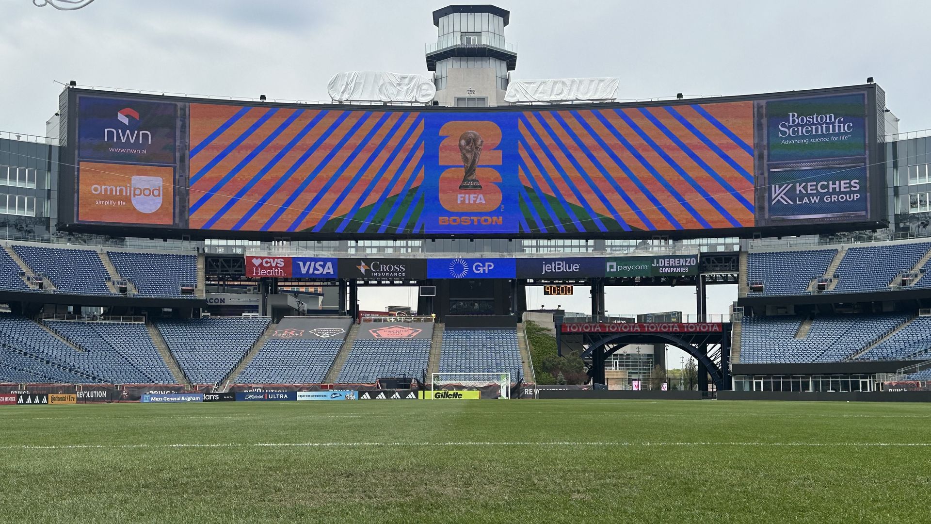 The field at Gillette Stadium in May with a large screen showing the 2026 FIFA World Cup logo. The name of the stadium is covered as Gillette is rebranding as "Boston Stadium" during the World Cup due to FIFA's sponsorship restrictions. 