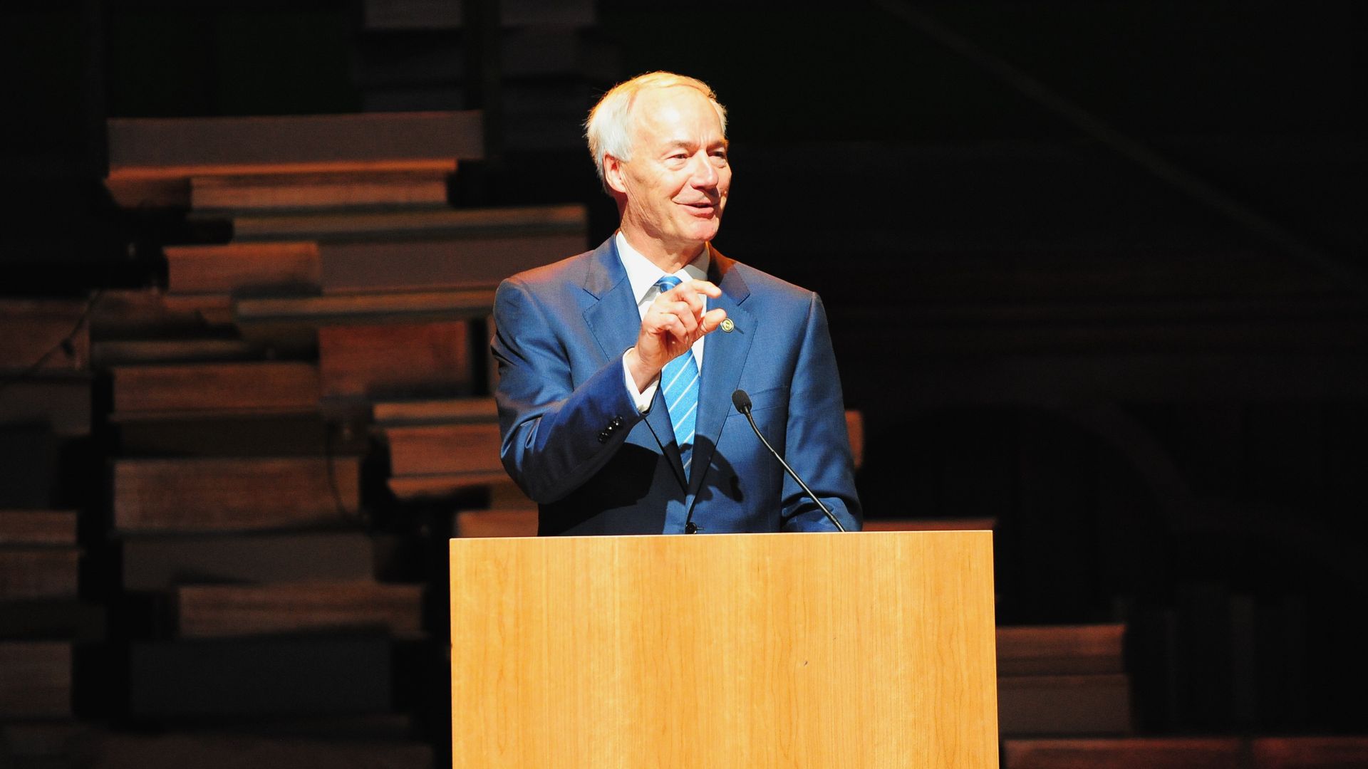 A photo of Gov. Asa Hutchinson speaking from a podium. 