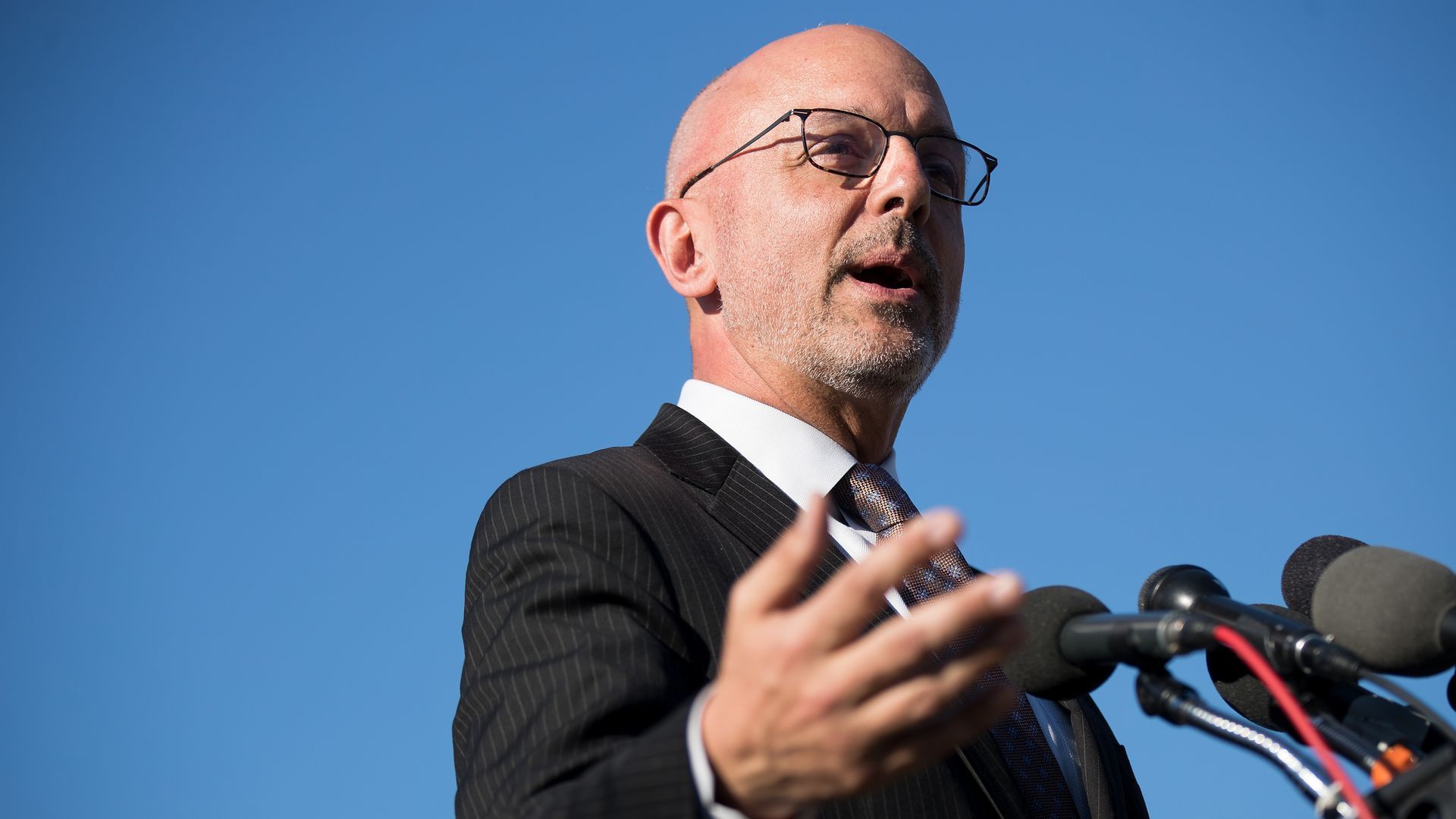 Photo of Rep. Ted Deutch (D.-Fla.) speaking at a podium with the blue sky above him