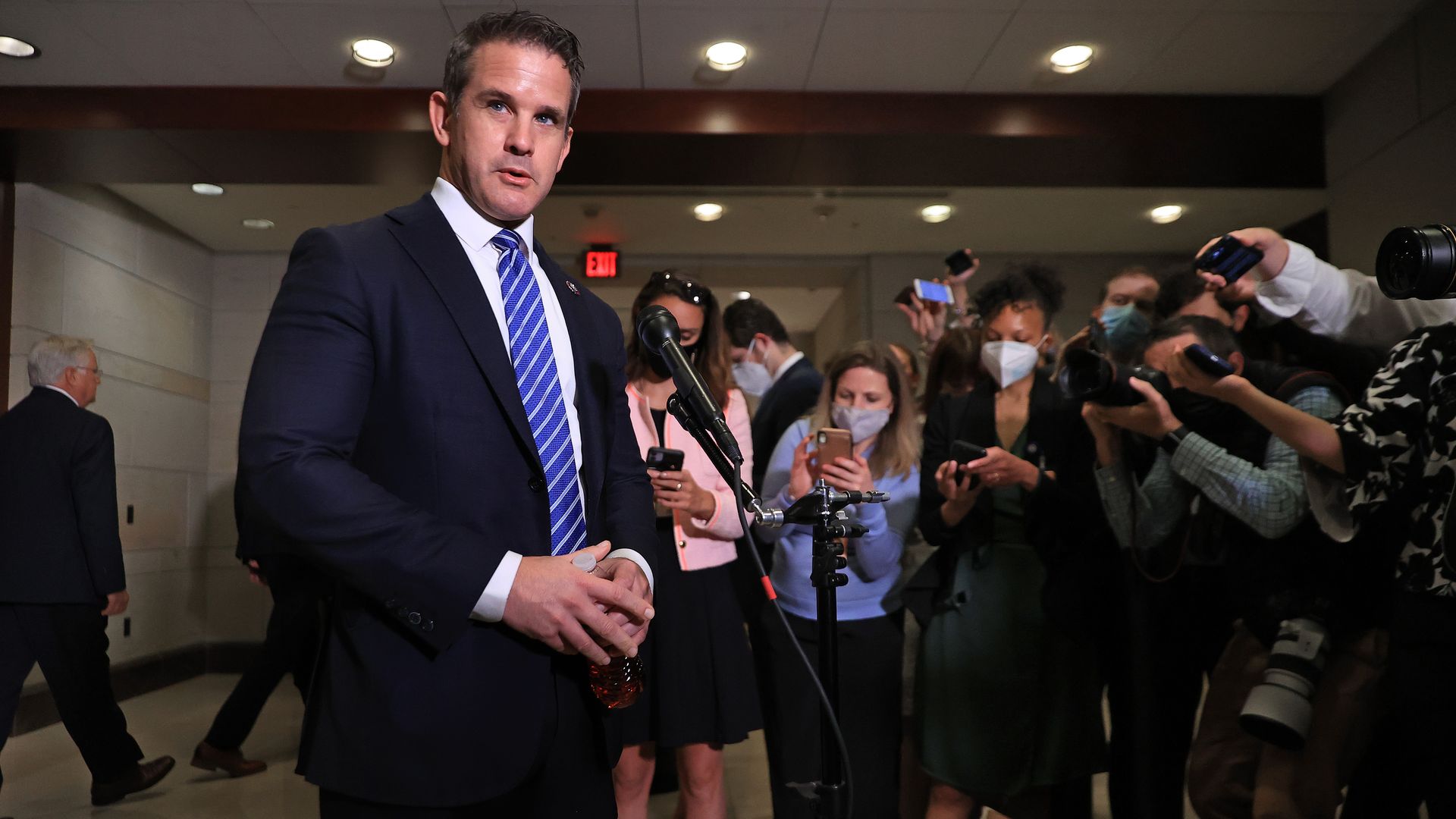 Rep. Adam Kinzinger is seen addressing reporters after Rep. Liz Cheney's ouster as Republican conference chair.