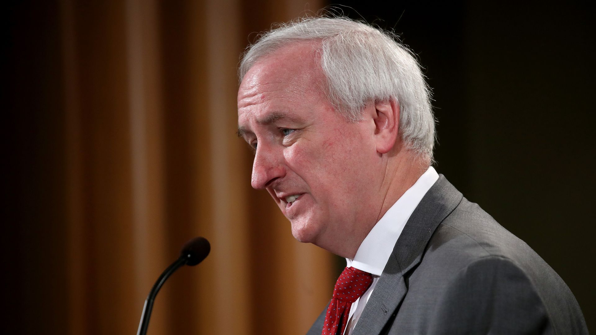 A photo of Deputy Attorney General Jeffrey Rosen standing at a microphone.