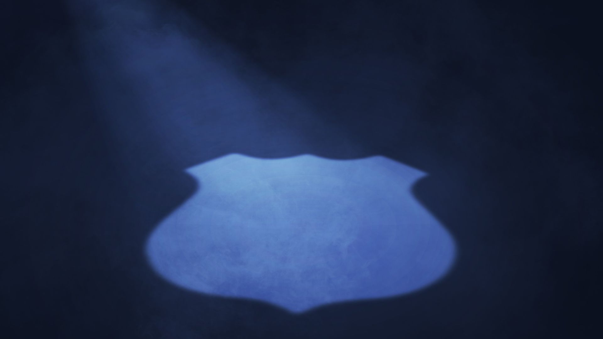 Illustration of a spotlight shaped like a police badge. 