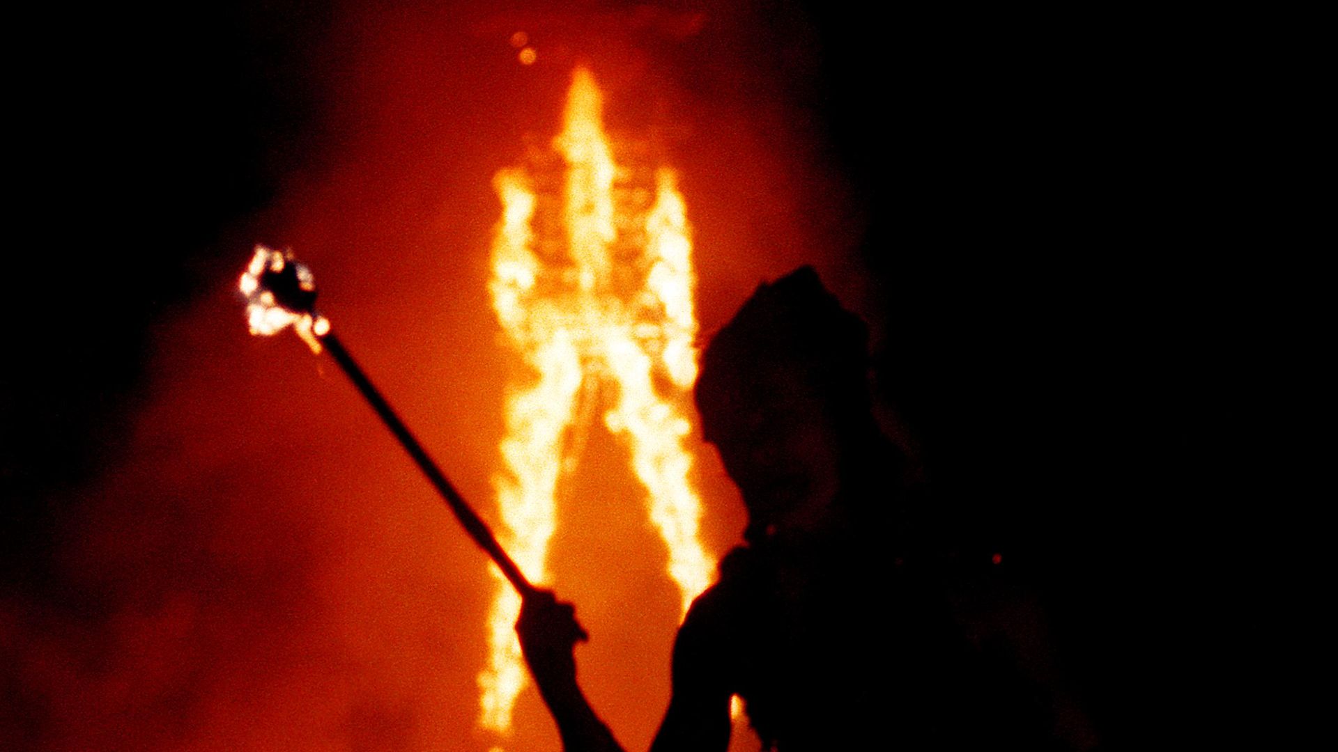 photo of a wooden structure being burned