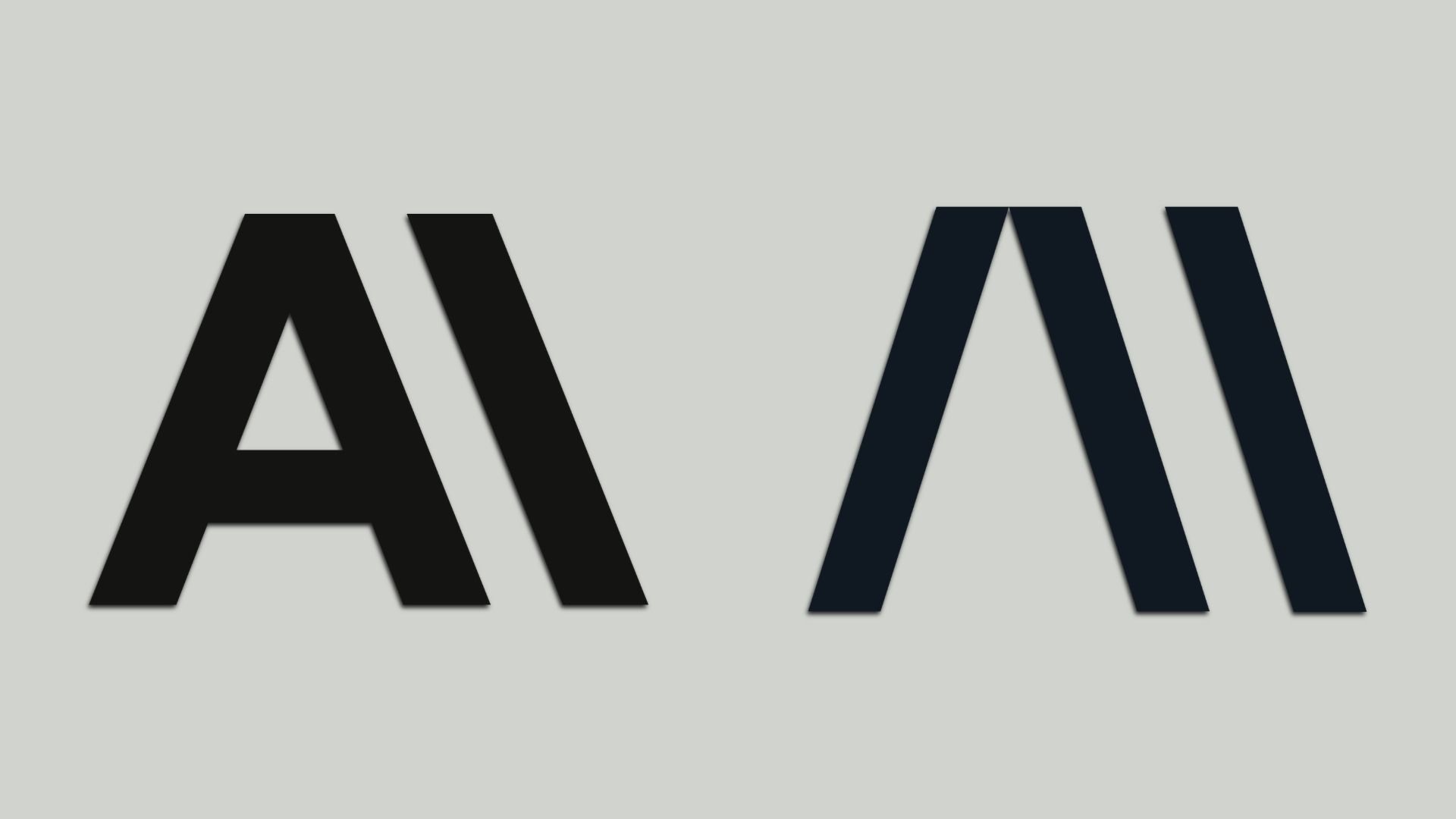 Two oversized uppercase A shapes on a pale gray background; the left A is black, the right A is dark navy, with the bottom portions cropped.
