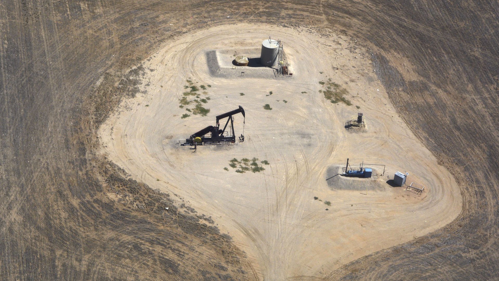 Oil and gas wells on Denver International Airport property as seen from a passenger plane landing at the airport in Denver, Colorado.