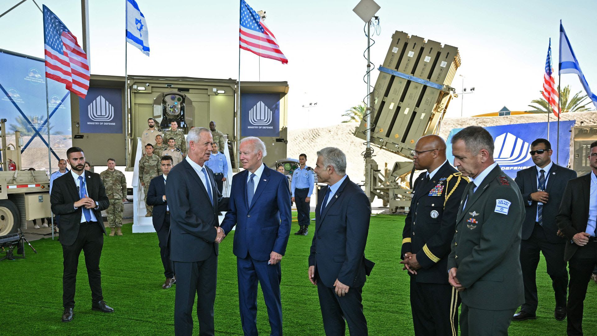 Biden (2nd R) shakes hands with Israeli Defence Minister Benny Gantz (L) as they tour with caretaker Prime Minister Yair Lapid (C),