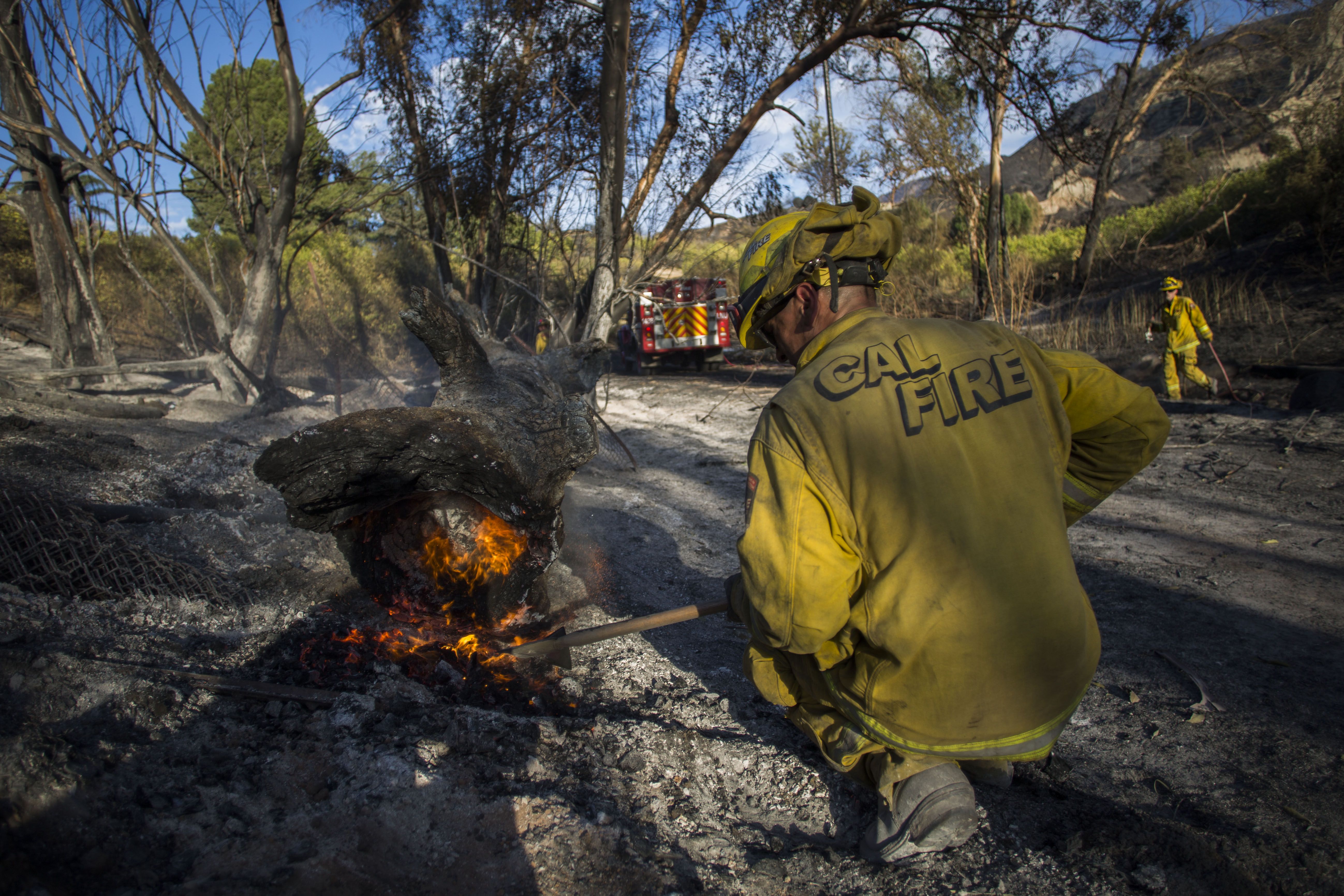  A firefighter controls a hotspot of the Maria Fire, in Santa Paula, Ventura County, California 
