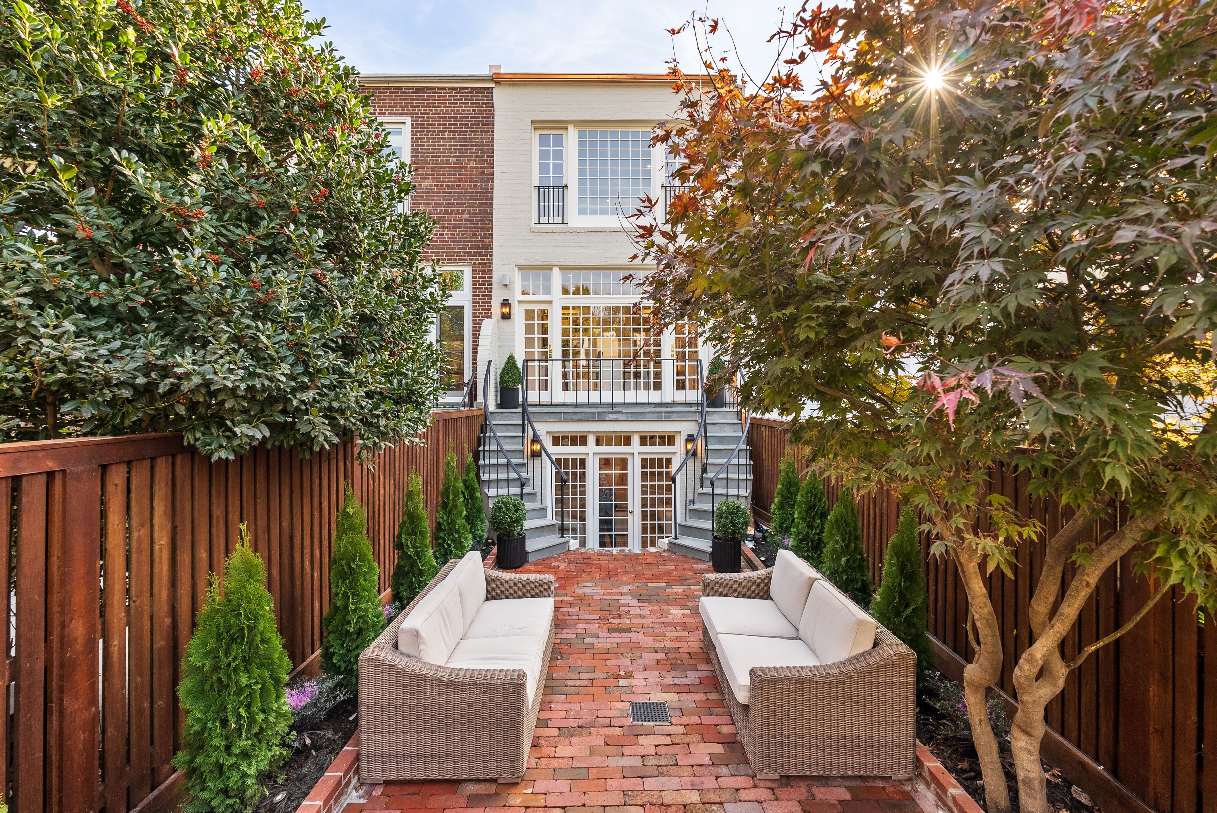 A photo showing the rear facade of a rowhouse, with a garden, in the Georgetown neighborhood of Washington, D.C.