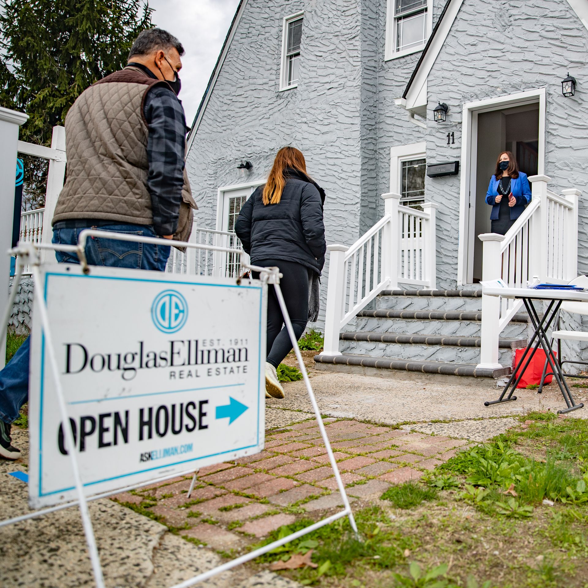 Image of people entering and existing an Open House for sale